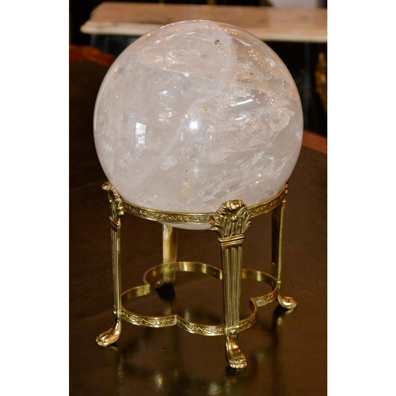 7 inch wide natural Brazilian rock crystal sphere resting on a removable French brass stand.
11 inches total height.