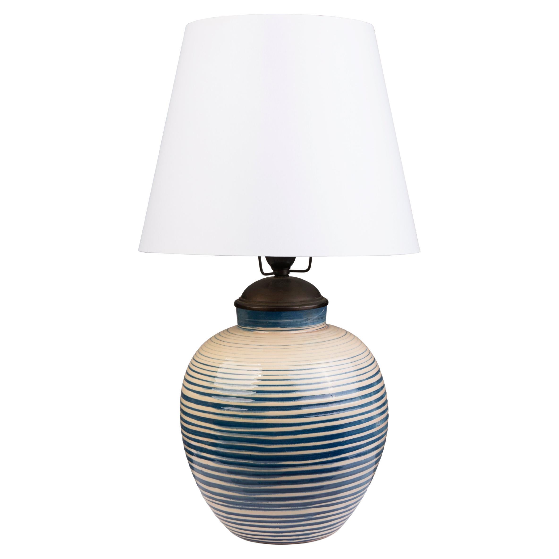 Large round table lamp with horizontal blue stripes on a creamy background For Sale