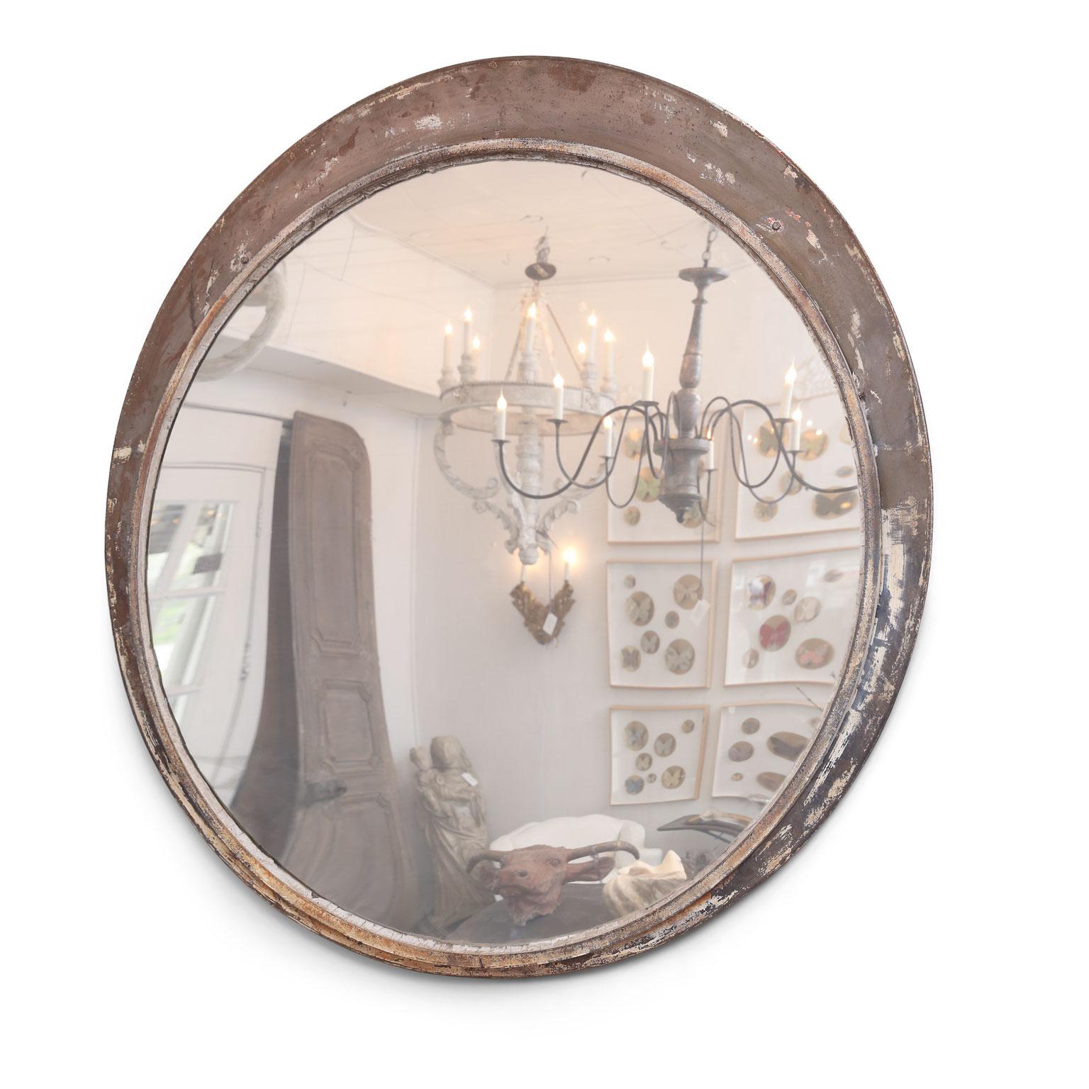 Large round train station mirror: early 20th century mirror in elliptical frame (used in a train or subway station in France). Naturally worn old painted finish over steel. Slightly convex original mirror.