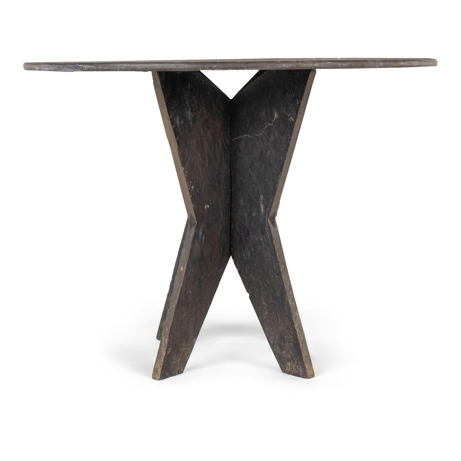 Large round vintage slate table from France, raised upon two-part shaped slate base.