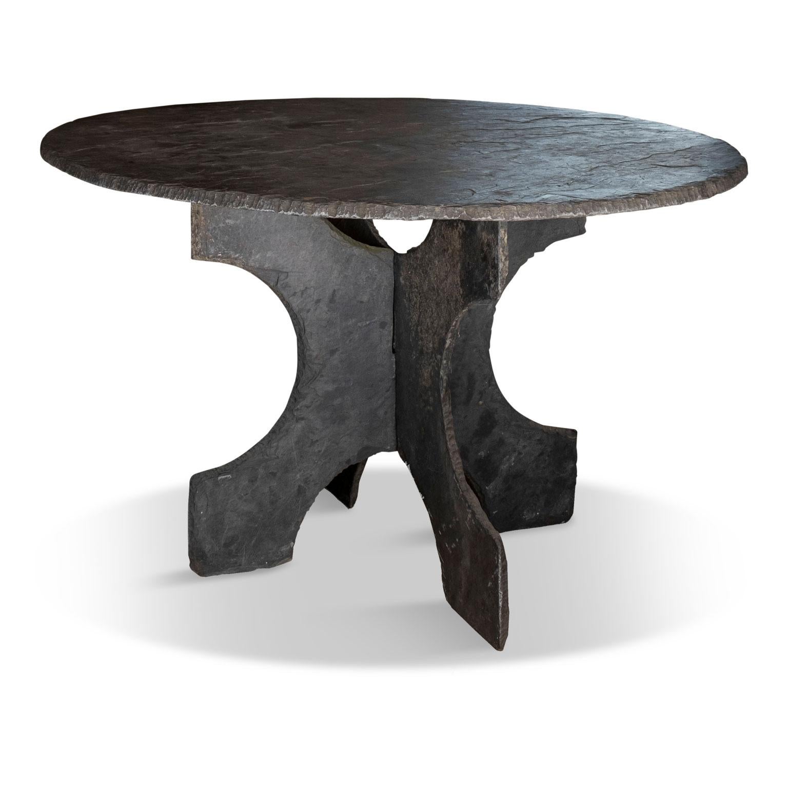 Large round vintage slate table from France, raised upon two-part shaped slate base.