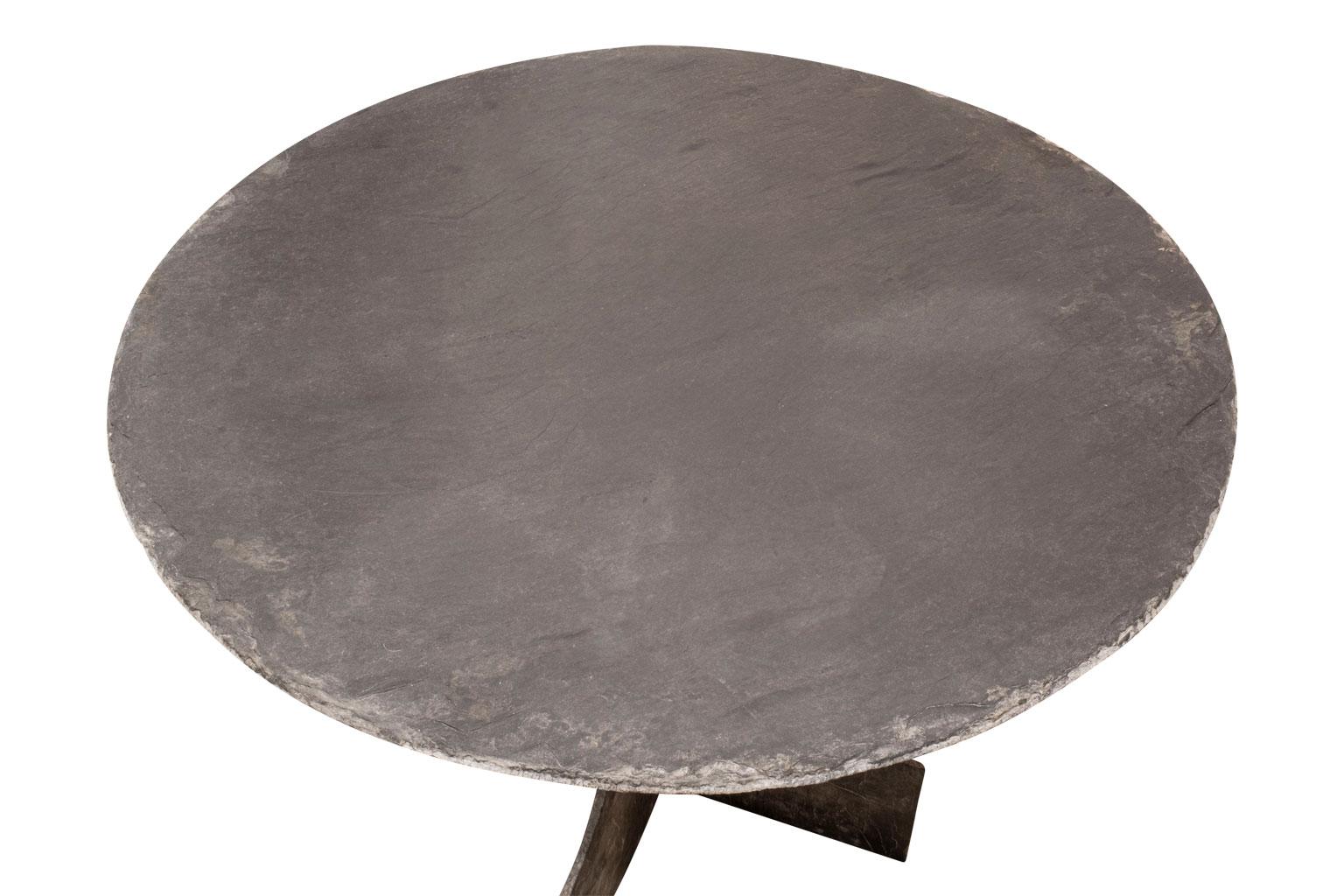 Large round vintage slate table from France, raised upon two-part shaped slate base. Small flecks of naturally occurring pyrite embedded in slate top (see last image).
