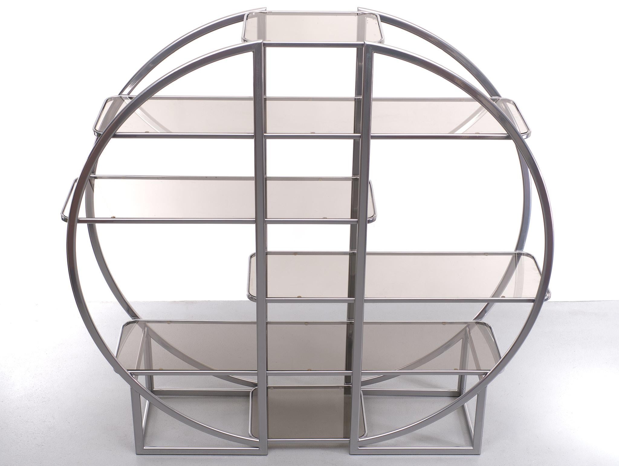 Beautiful chic round étagère, room divider, vitrine or to showcase your collection comes with six variously sized smoked glass shelves. This piece can be put against the wall but is also great to use as room divider. Amazing eye-catching piece and a