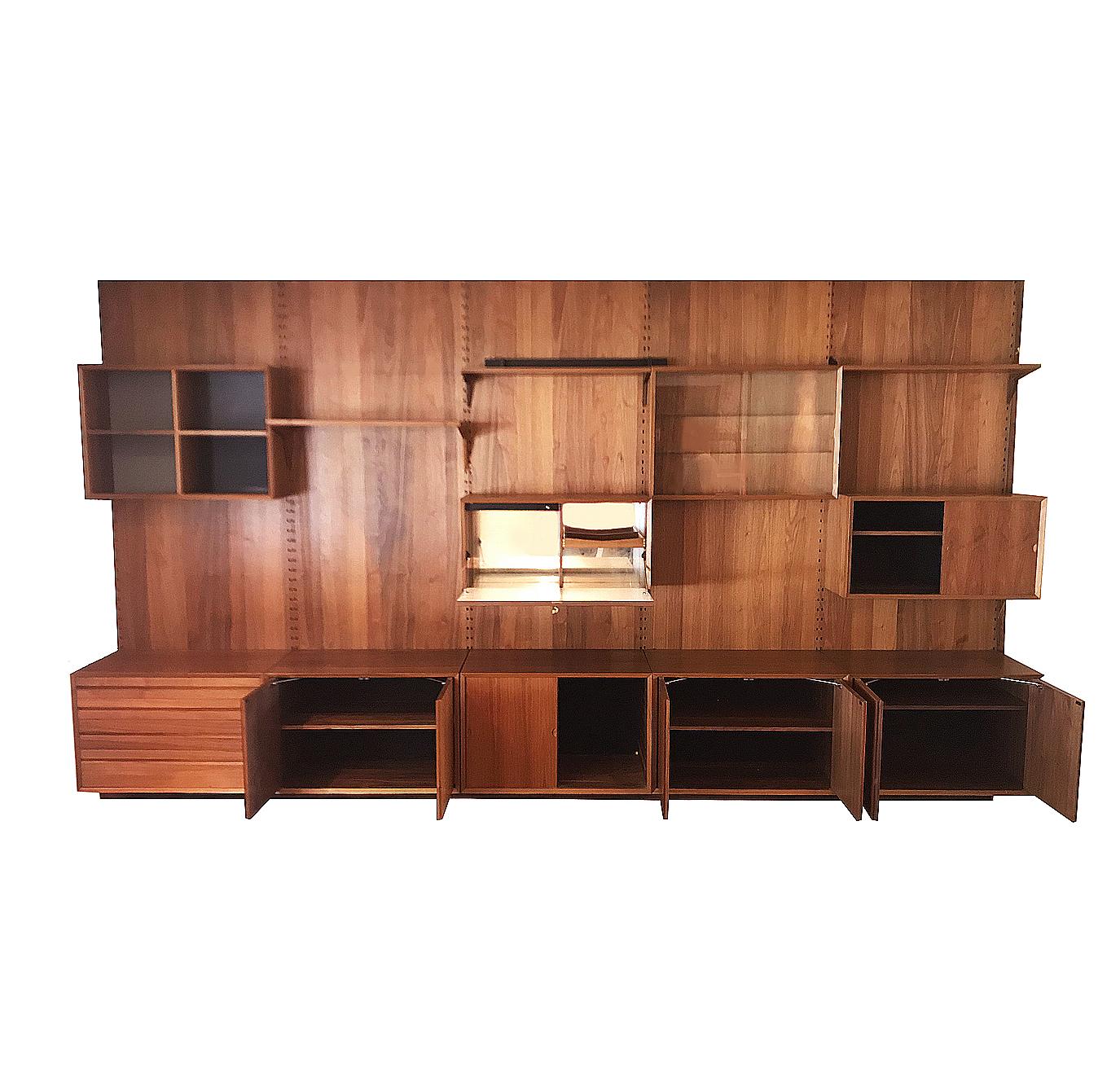 Here we have a large wall unit designed by Poul Cadovius for Cado Systems. This unit consists of five wall mounting pieces with many cabinet components and shelves as shown. It is completely modular and can be arranged to your liking. This was