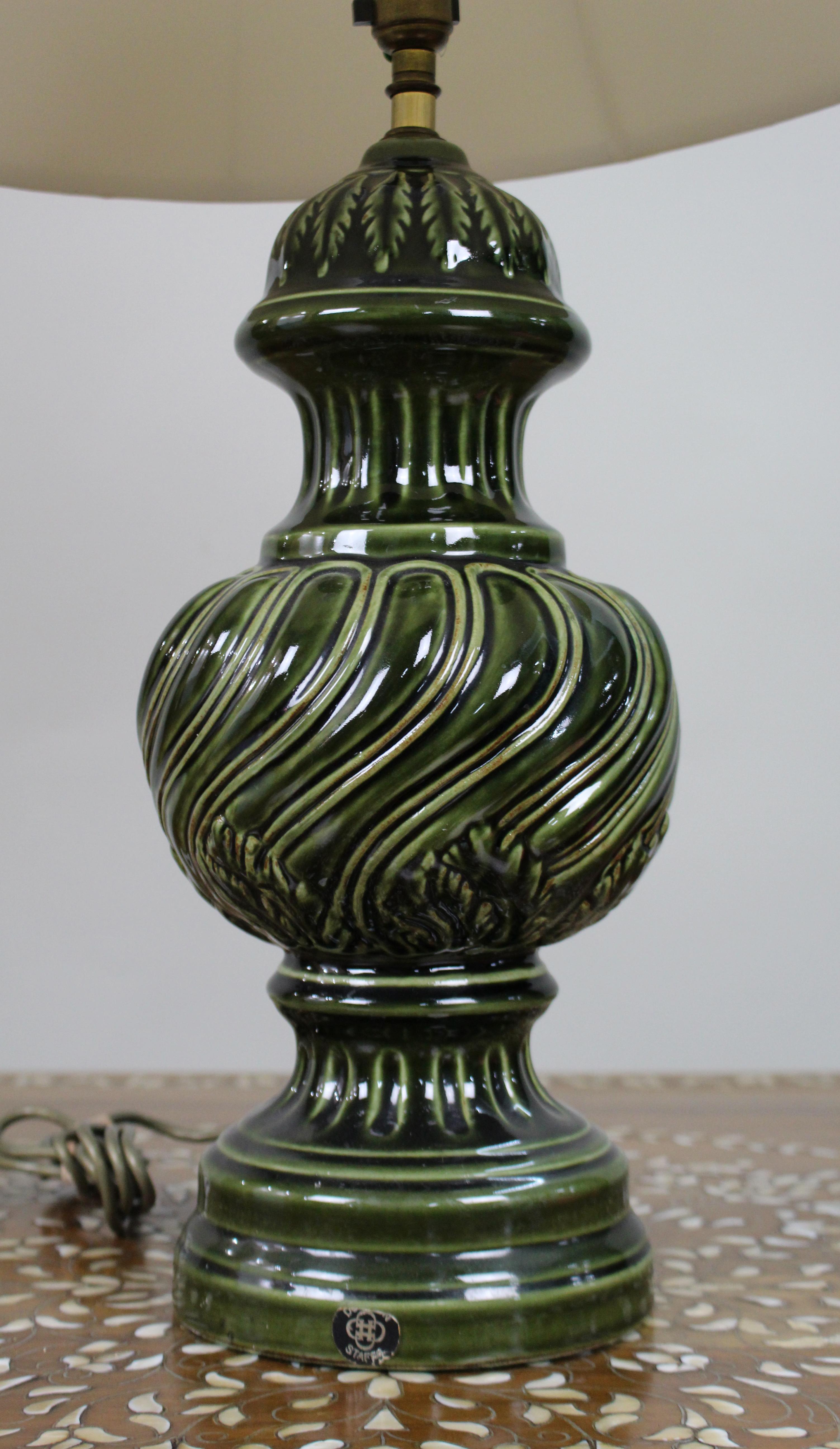 Large Royal Doulton Green Glazed Ceramic Table Lamp with Shade

A striking and sculptural table lamp by Royal Doulton, England, dating from the mid-20th century.

The generously proportioned body is formed in ceramic with deeply moulded, swirling