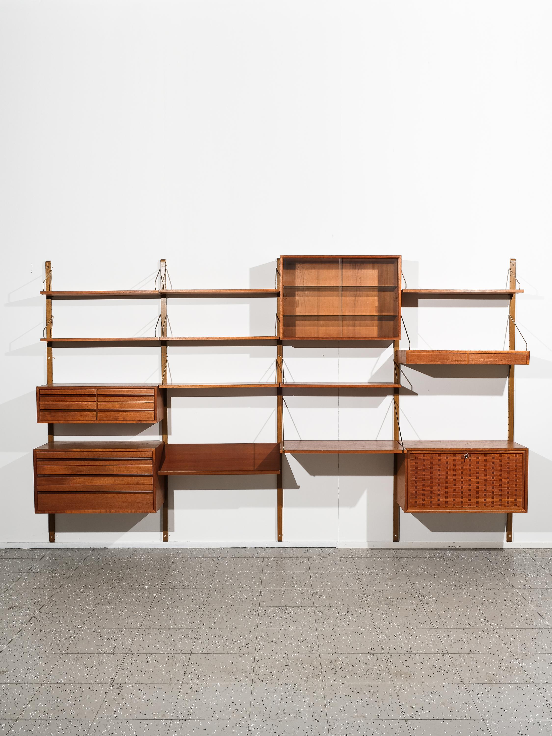 Great XXL size Danish modern teak wall unit ”Royal System” designed by Poul Cadovius, circa 1960s. 

This piece contains 9 shelves, one cabinet with glass sliding doors, one with drop-down door and three with drawers. This piece is completely