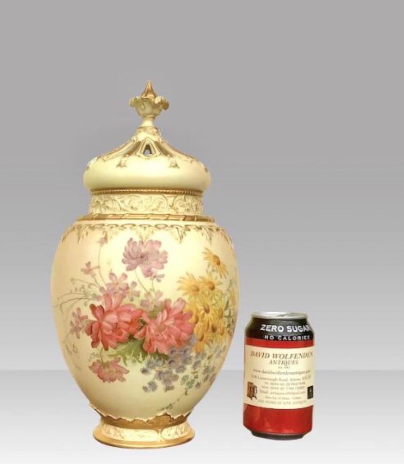 A large Royal Worcester blush ivory ground ovoid pot pourri jar vase and crown cover, complete with inner cover and domed and pierced out cover with gilt decoration and finial, the body florally decorated in coloured and gilt highlights, printed