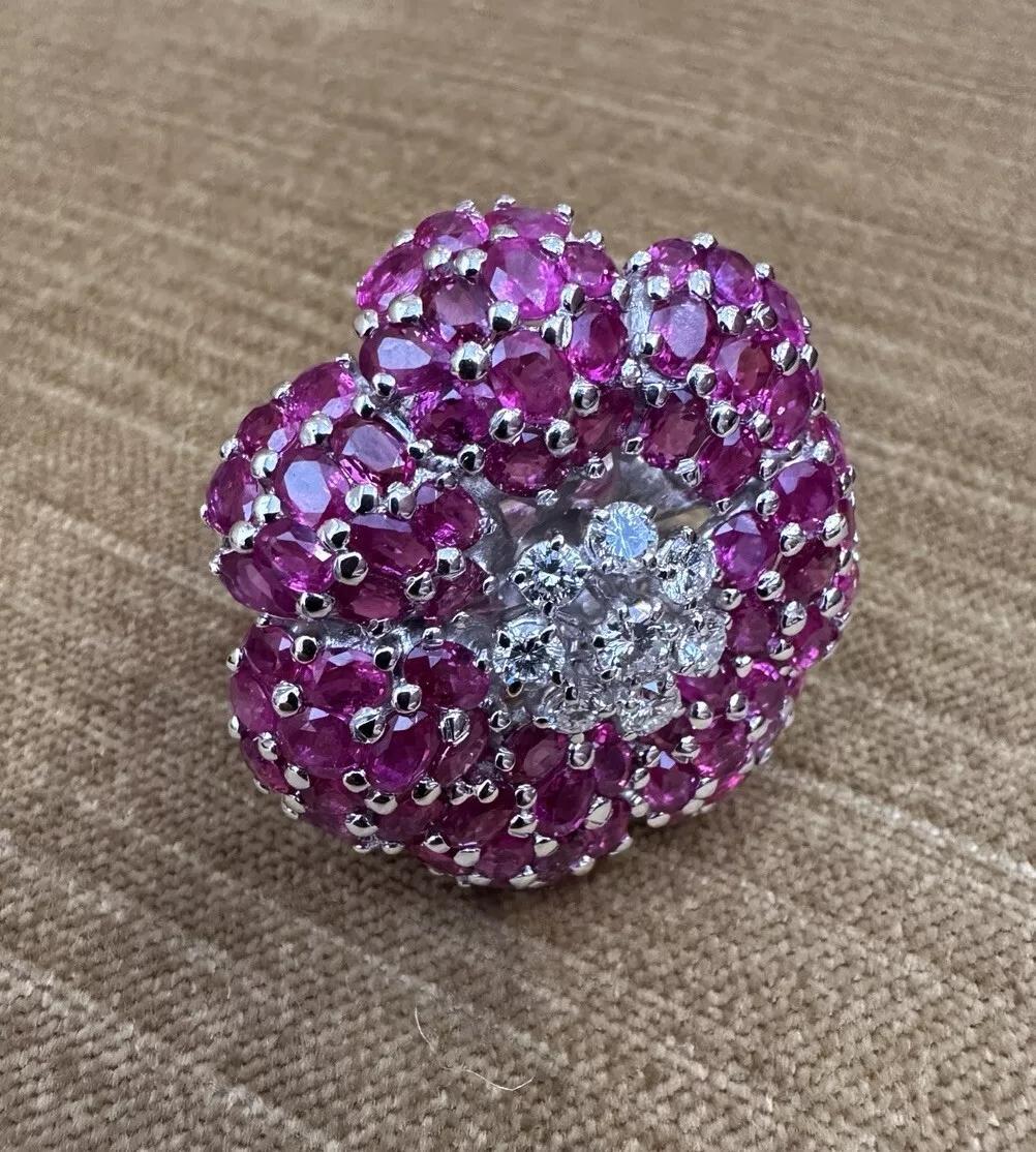 Large Ruby and Diamond Flower Cocktail Ring in 18k White Gold 

Ruby and Diamond Cocktail Ring features 7 Petals made of Natural Oval Pinkish Red Rubies pave set around a center of Round Brilliant Diamonds, all set in 18k White Gold.

Total ruby