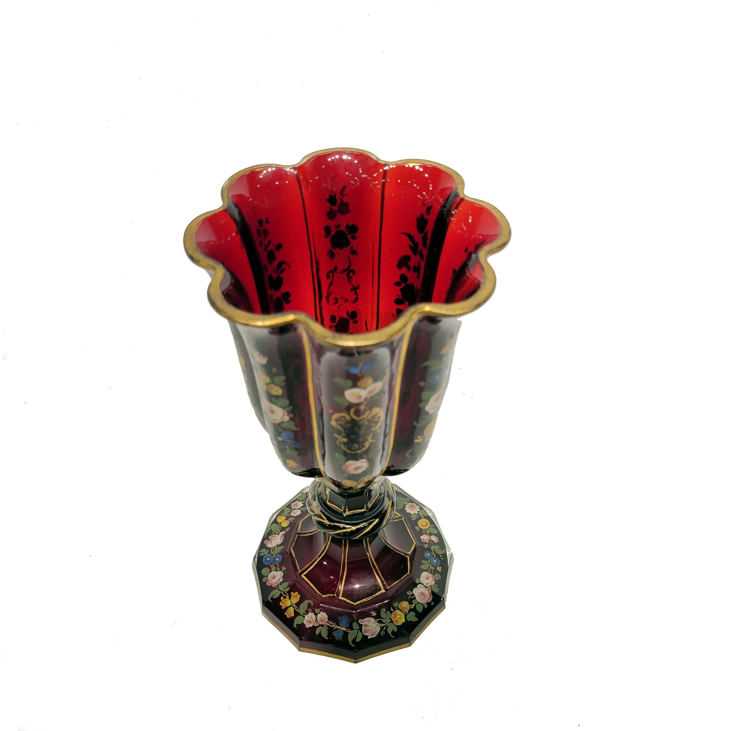 A wonderful rare and quite large Bohemian ruby red footed goblet circa late 19th century. Hand painted enamel flowers and gold decoration. The glass is a rich ruby red color which has been hand blown and hand polished to perfection. This goblet was