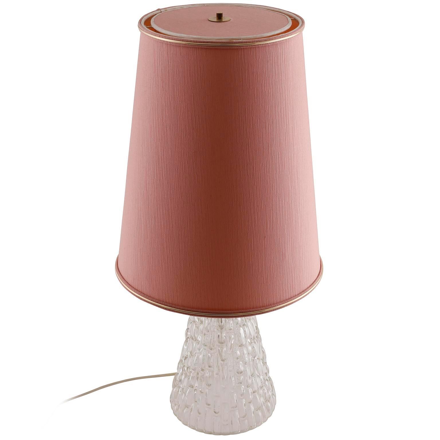 A large table lamp by Rupert Nikoll, Vienna, Austria, manufactured in midcentury, circa 1960 (late 1950s or 1960s).
The textured glass base has a bulb socket for a small screw base bulb (E14 candelabra) inside. The pink or old rose original lamp