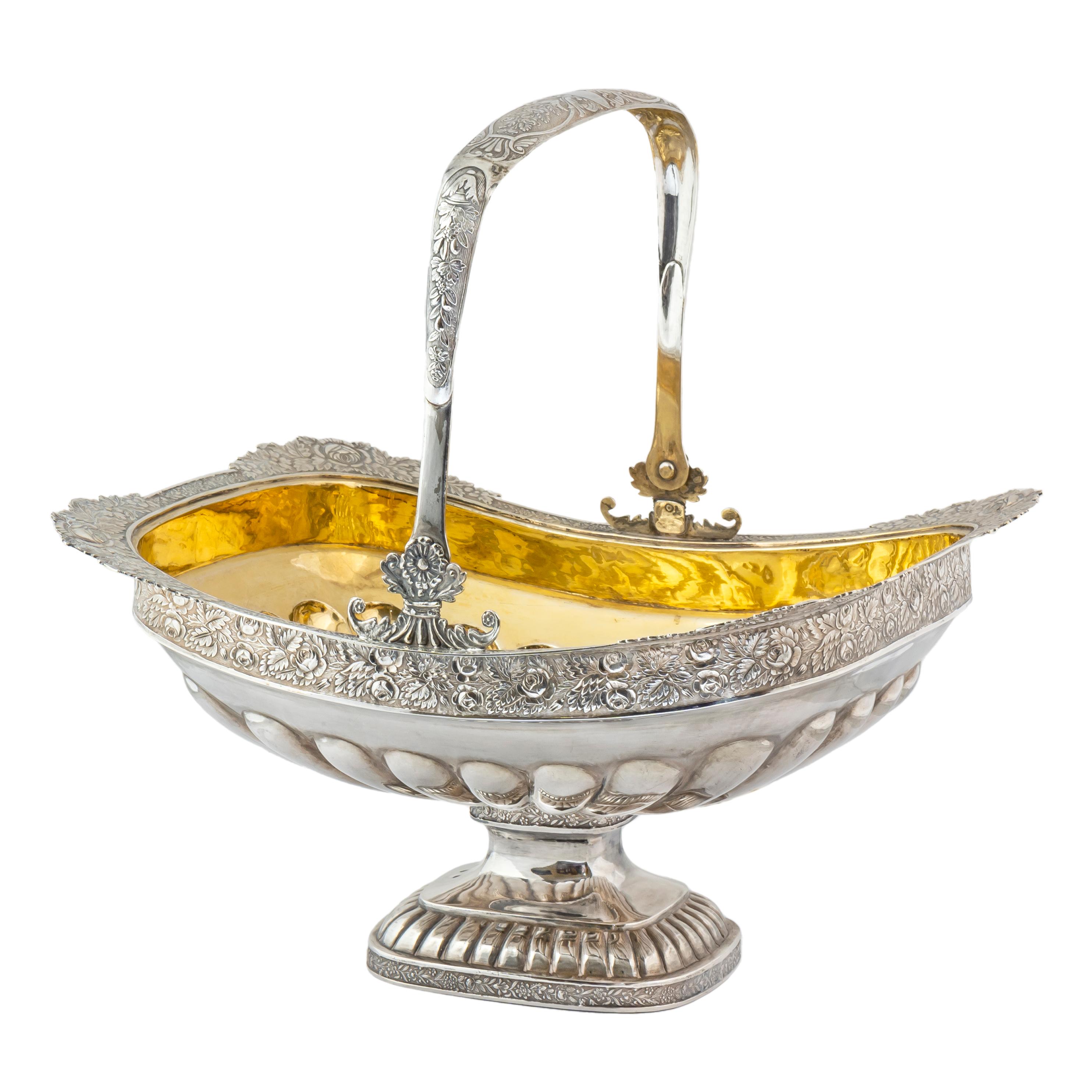 In the Romantic taste, this elegant Russian silver-gilt basket was made in the imperial capital of St. Petersburg in 1830 during the era of Tsar Nicholas I. The interior is lobed and gilded while the exterior is decorated with a band of repoussé,