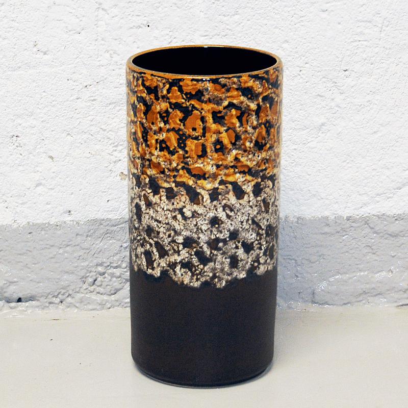 Lovely large earth colored and charcoal grey vintage ceramic vase from West Germany 1970s. Cylindershaped rustic vase with mustard yellow and white knitting design motives on the upper part and plain charcoal black lower part. Glazed dark brown