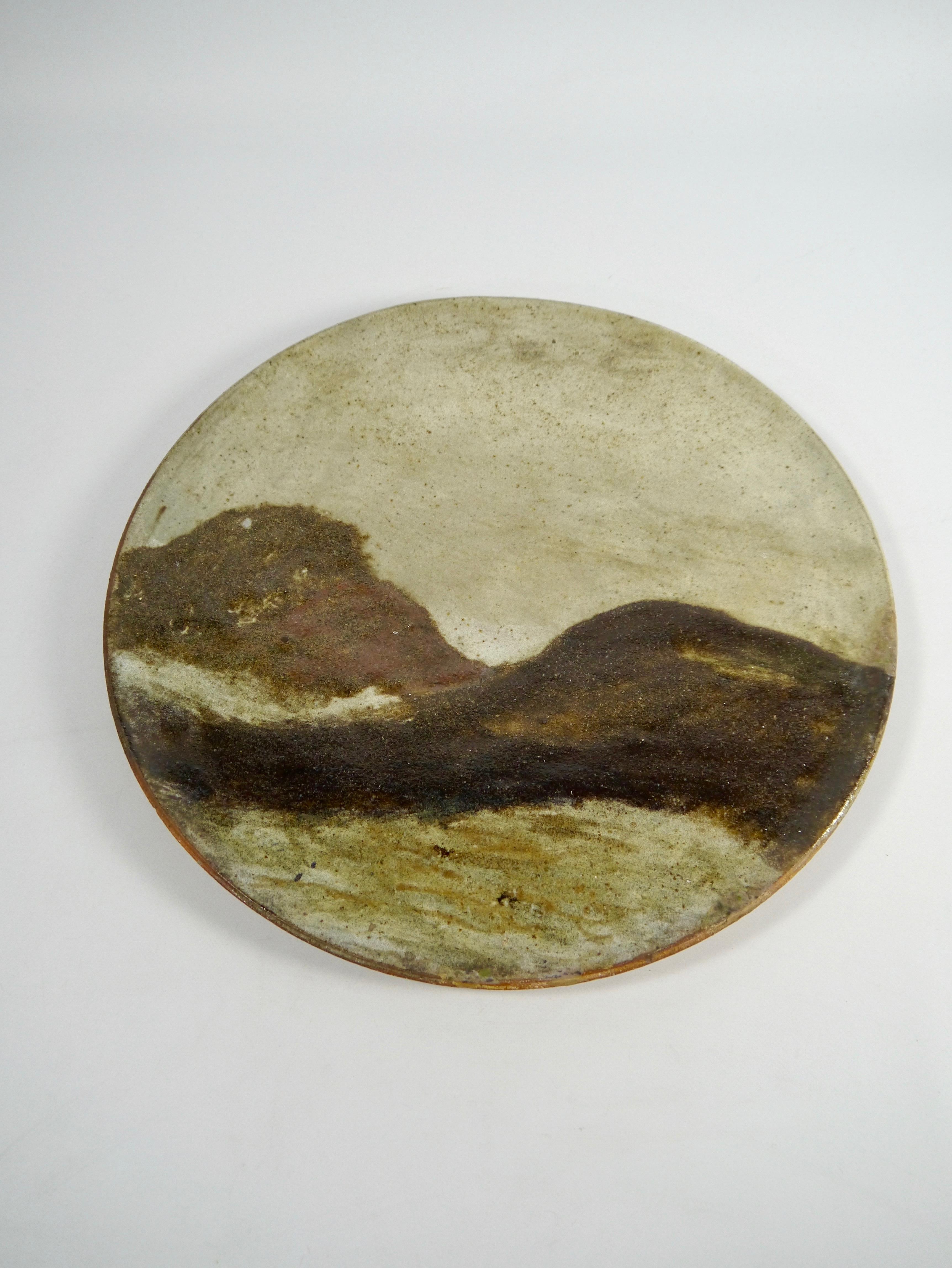 Rustic earthy colored tones ceramic platter (prepared for wall-mounting), made by Norwegian ceramist Osvald Osmundsen in the 1970s. Ondulated shapes, reminiscent of the yin-yang symbol or a wave or a landscape... Rustic, wabi-sabi, boho chic. 