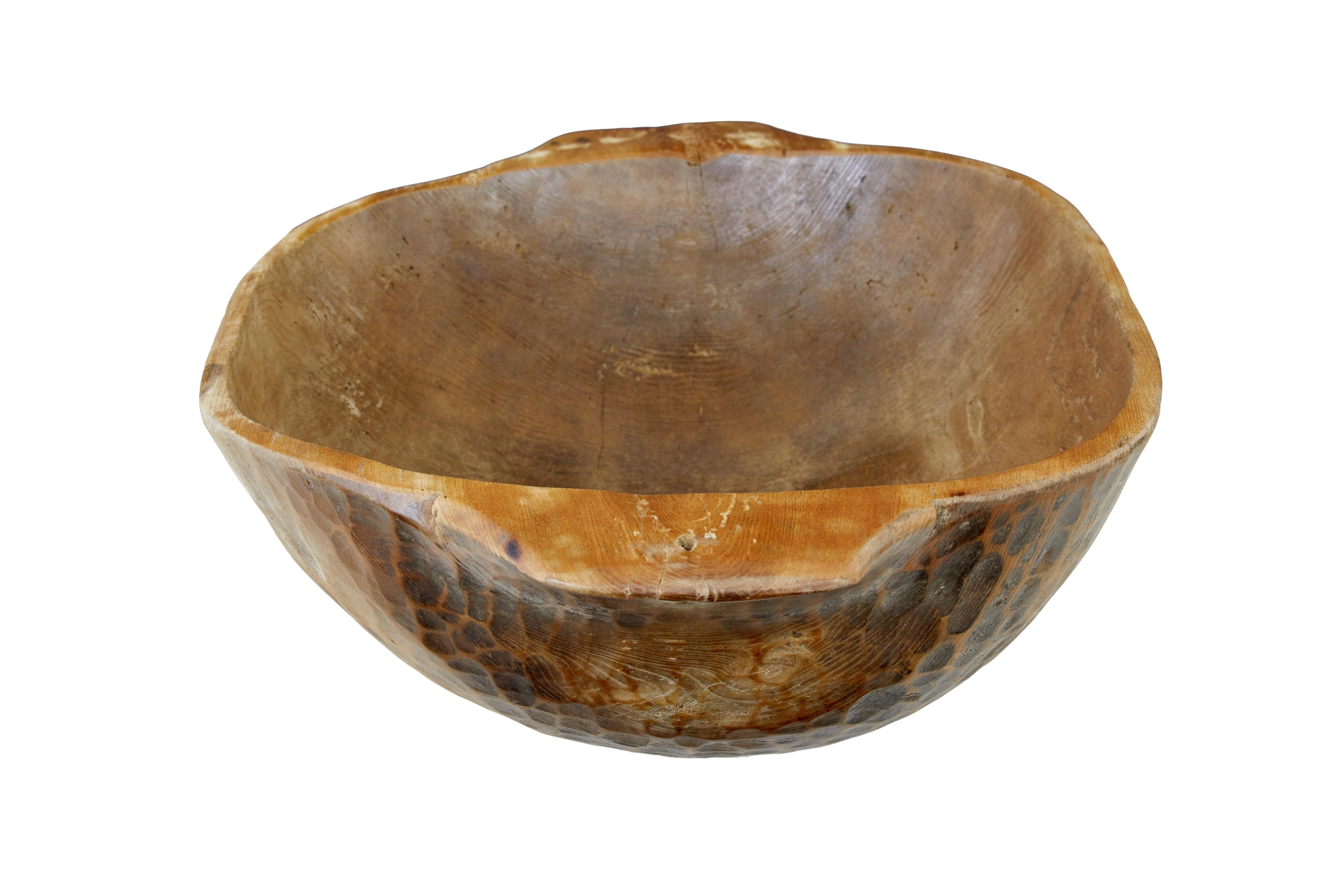 Large rustic dugout hand carved bowl circa 1900.

Hand made eastern european bowl.  These types of bowls were often used to feed livestock.  Made from a solid tree trunk section and hollowed out using an adzed technique.

This bowl is presented
