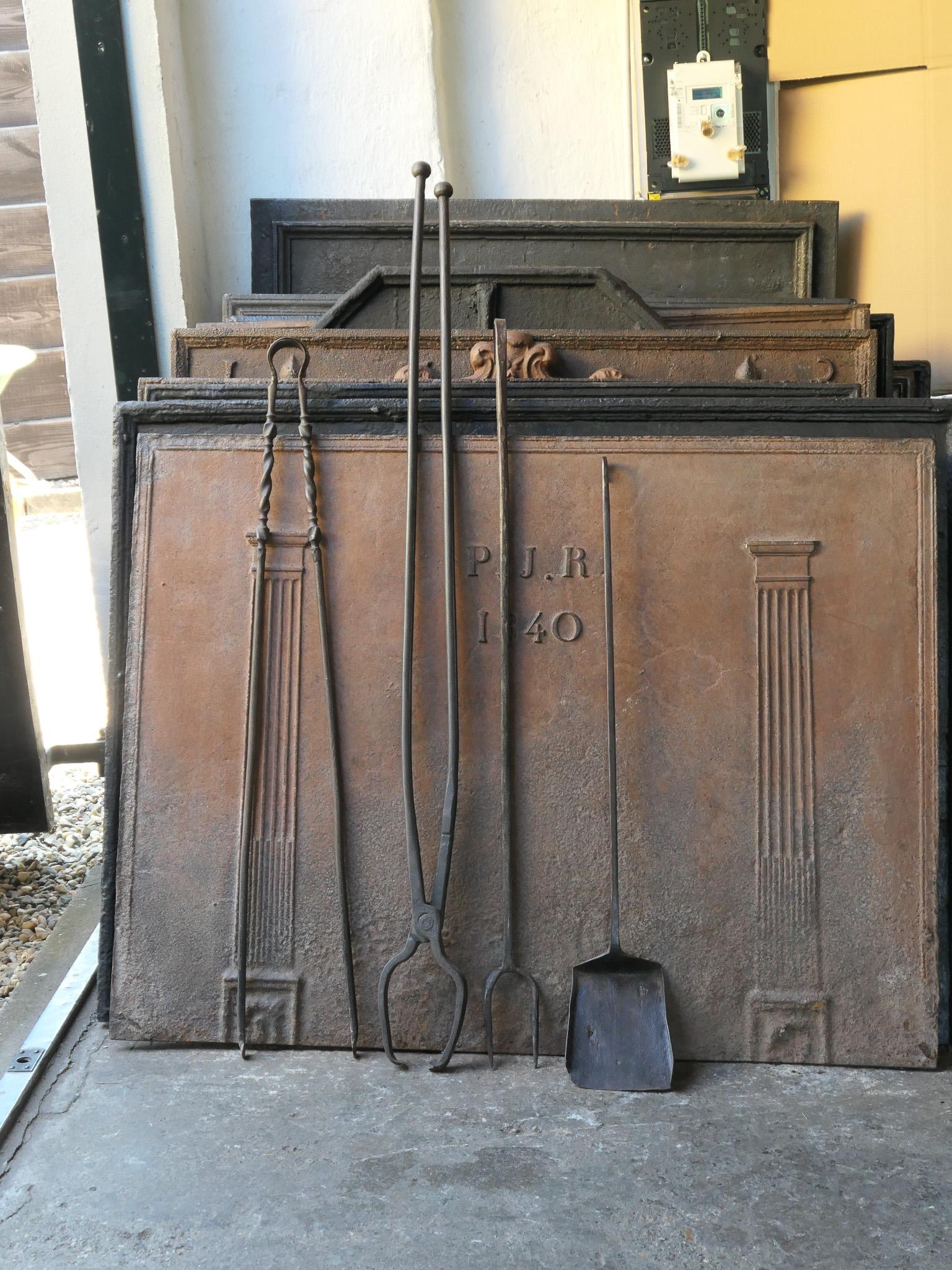 Large 18th-19th century French fireplace tool set. The tool set consists of fireplace tongs, shovel, fire fork and log tongs. The tools are made of wrought iron. The set is in a good condition and fit for use in the fireplace.