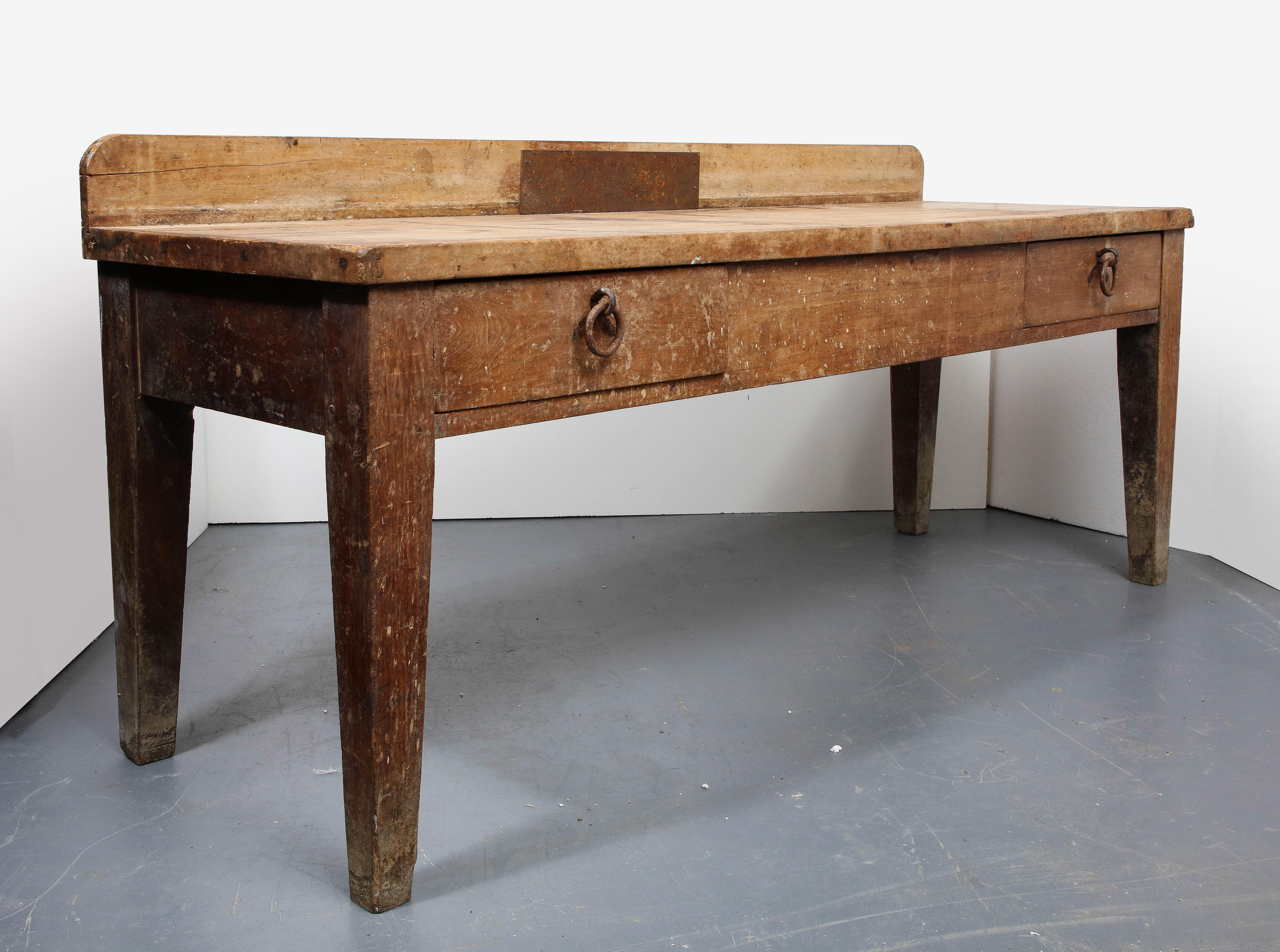 Large rustic work table, France, 19th Century 

This rustic work table consists of an oak plank construction, original iron hardware, and a stunning antique patina. 

The table is highly stable and structurally sound with scratches and wear