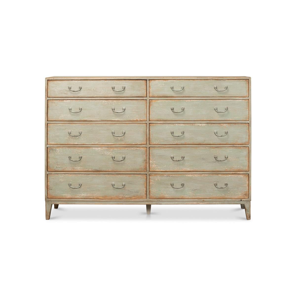 A rustic painted chest of drawers crafted from pine. This beautiful piece has been given an antique finish in a sage green color. It boasts eight drawers making it the perfect piece to maximize storage. 

Dimensions: 72