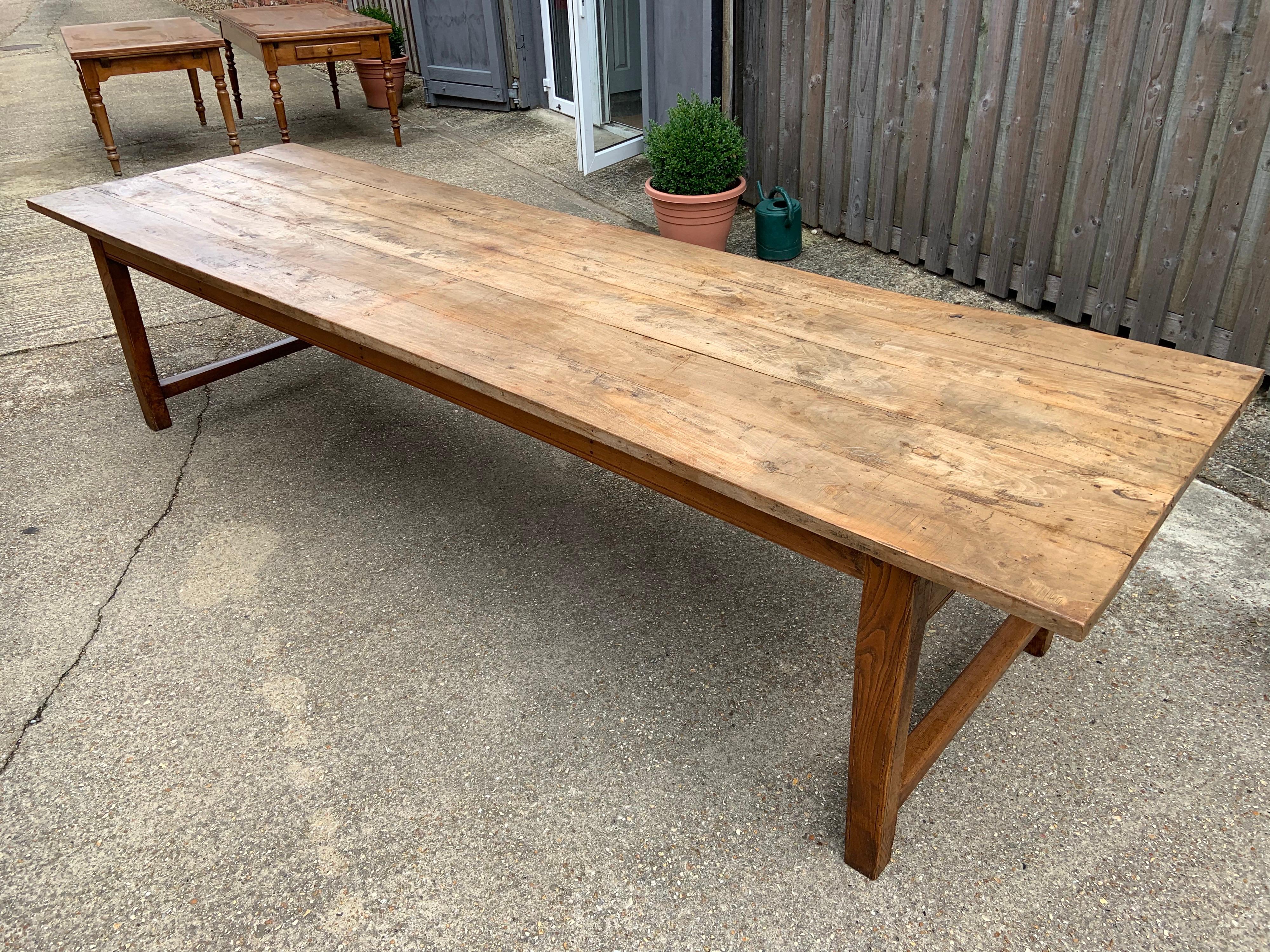 Large pale rustic elm farmhouse table with sturdy end H stretcher and large end drawer. Rustic five plank top with gorgeous color. Great proportions on this table. Would seat 12 people comfortably.
