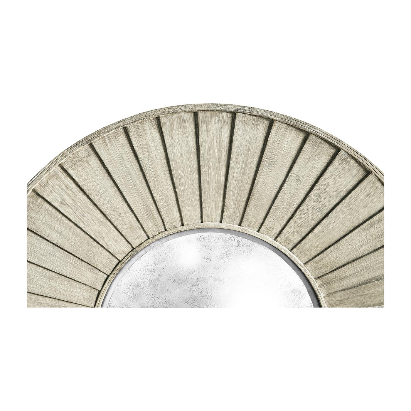 Crafted from layers of washed acacia wood, its circular frame echoes the grandeur of an airplane engine, making it a bold yet sophisticated statement piece. The natural wood grain and artisanal layering create depth and texture, bringing warmth and