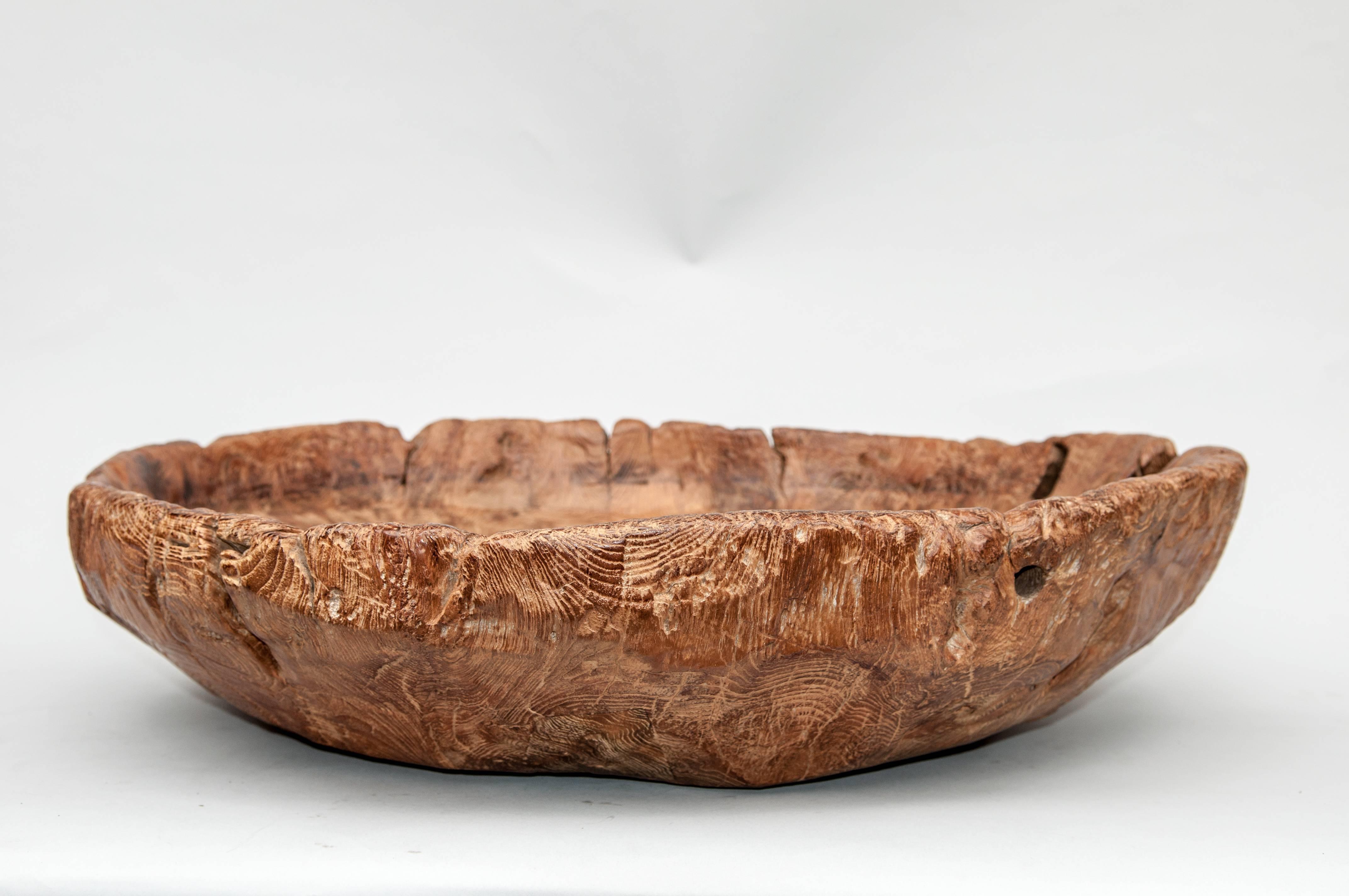 Large rustic teak bowl fashioned from an old Mortar. Java, late 20th century.
This rustic wooden teak bowl was fashioned by hand from a single piece of very old and very rugged teak, most probably from an old teak mortar from Madura, Java, an area