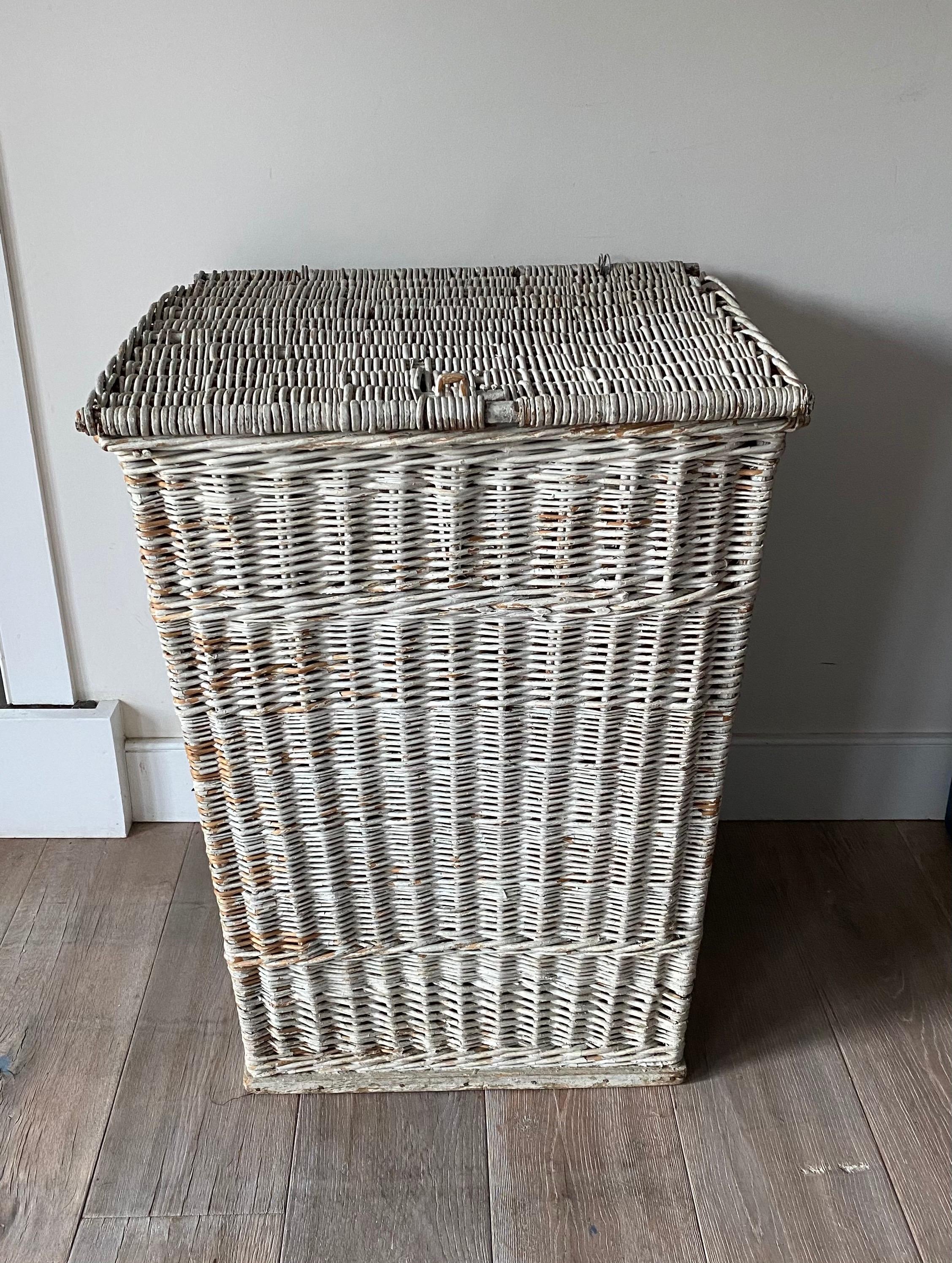 A large vintage rustic wicker basket with lid. Original white painted finish with excellent patina.