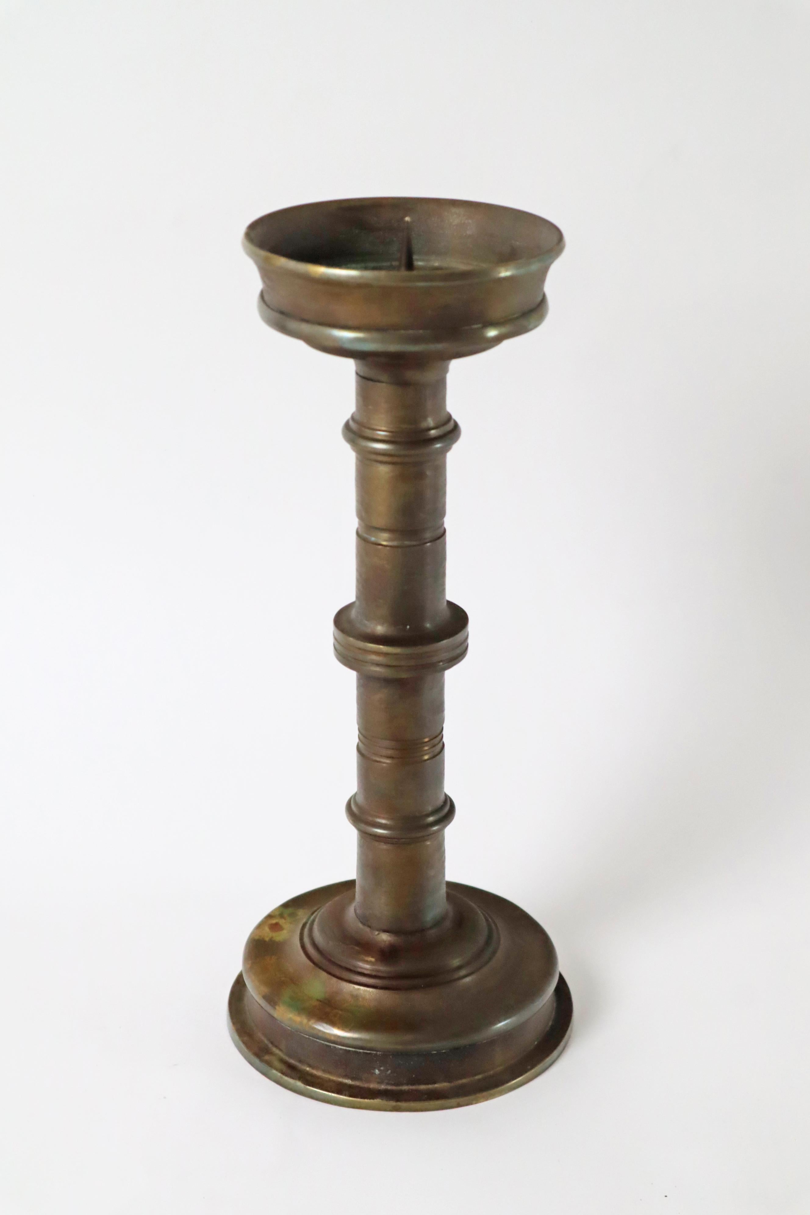 Questo portacandele a colonna emana un'atmosfera sacra grazie alla sua lavorazione semplice e di alta qualità. Questo candeliere proveniva originariamente da una chiesa, dove è stato utilizzato per molti anni. La solida lavorazione e il design della