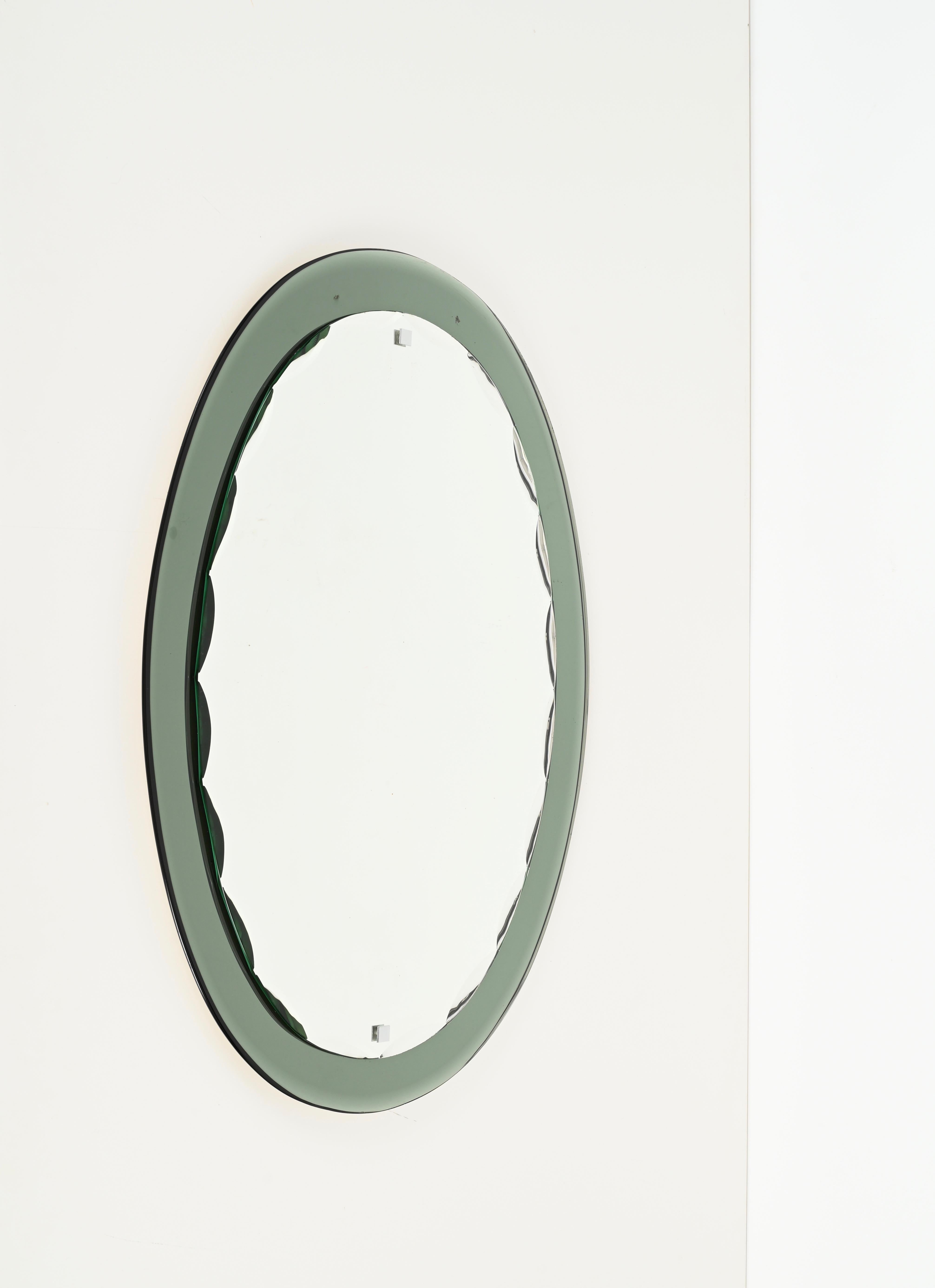 Marvelous sage double beveled oval mirror designed by Antonio Lupi and produced by Cistal Luxor in Italy during the 1960s.

This mirror has a stunning sage colored crystal beveled mirror frame that shades from a light green to a soft grey depending