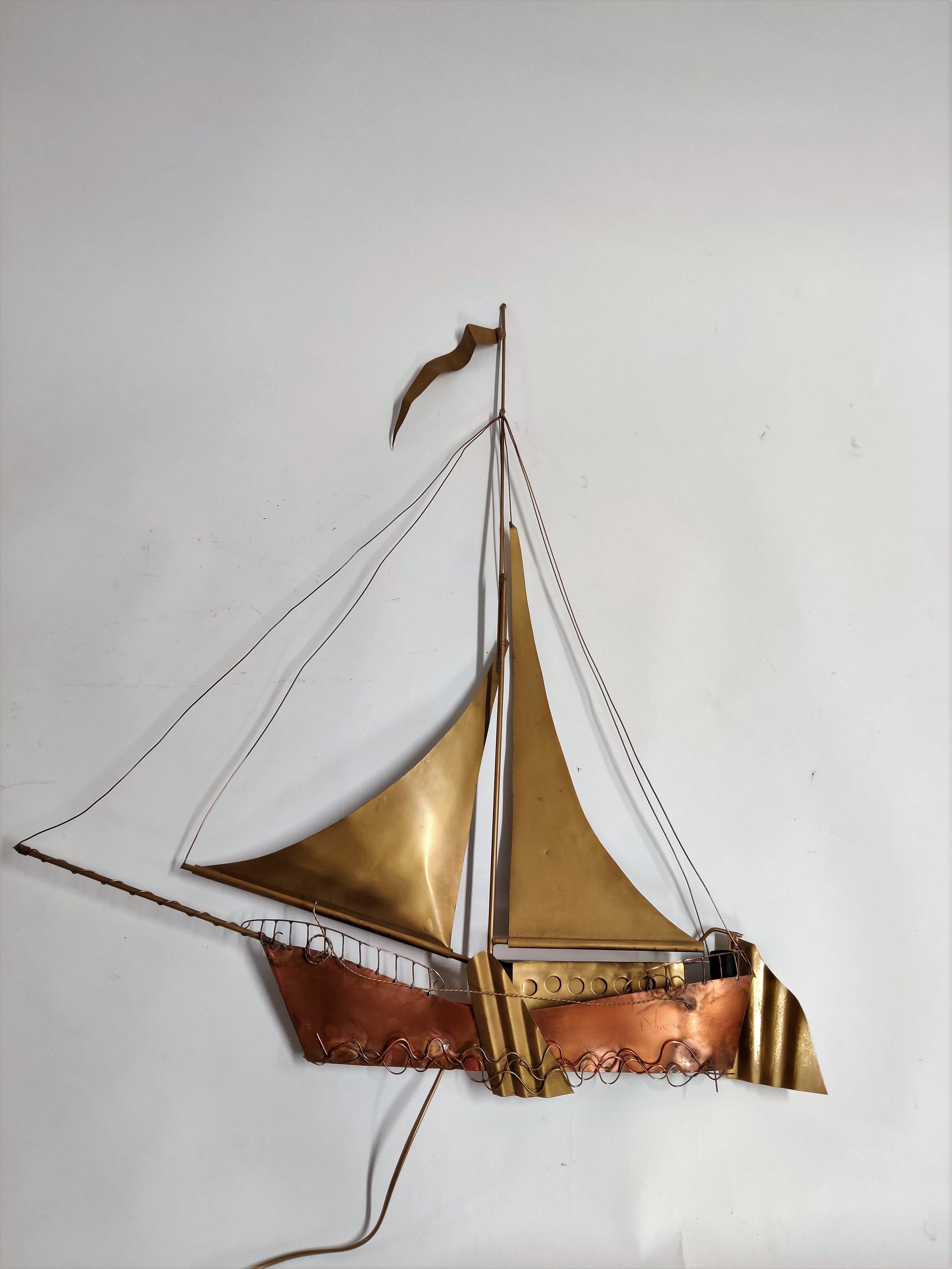 Large, handmade copper and brass wall light sculpture in the shape of a sailing ship by Belgian artist Daniel Dhaeseleer. 

The piece is signed at the front. Two screw bulb light fittings are worked into the frame, creating a wonderful shadow