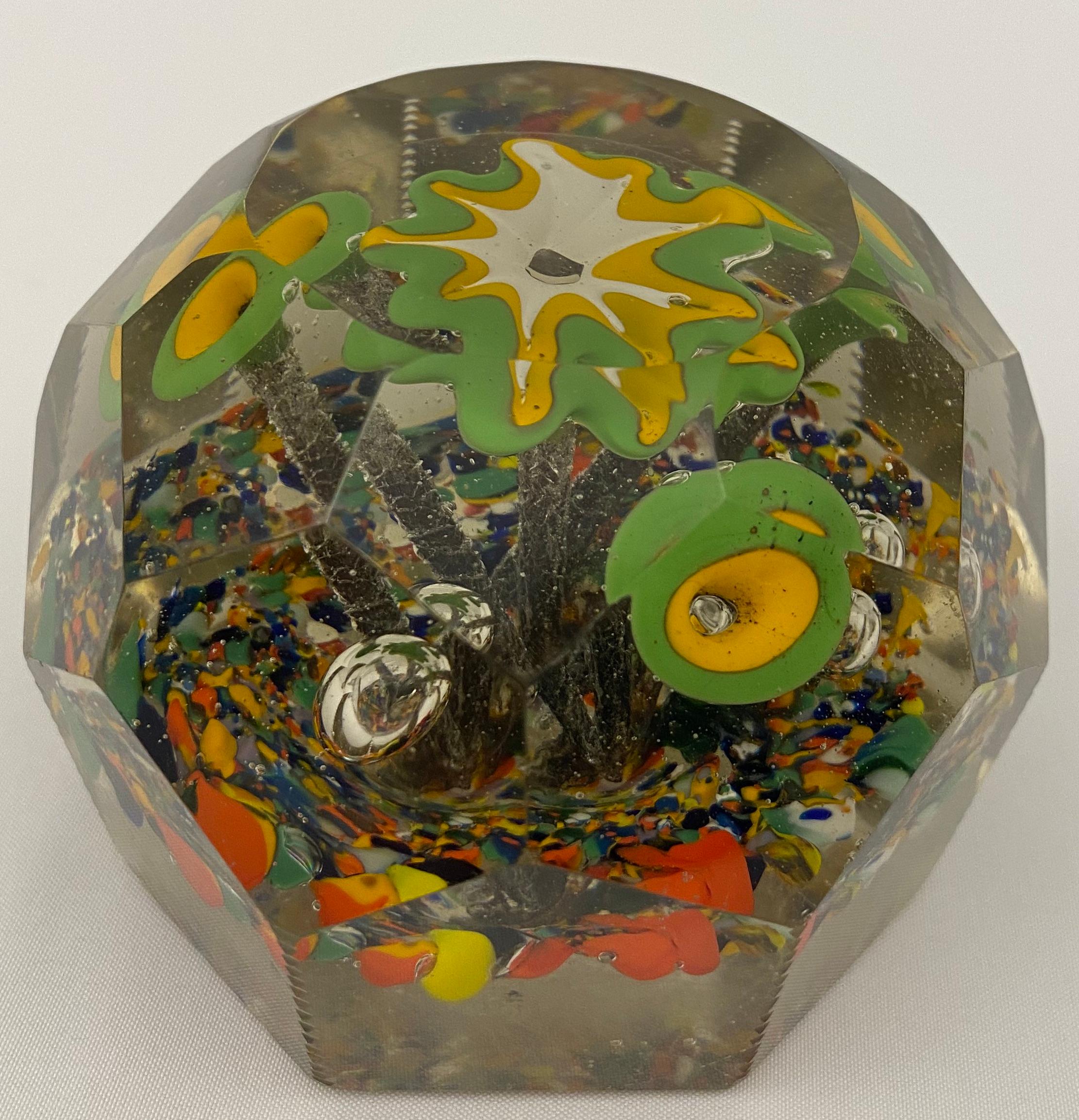A stunning paperweight dating back to the late 19th Century with roses and flowers that will spark your imagination every time you put your eyes on it. 

This art piece has faceted edges and controlled bubbles, created by Saint Louis Cristallerie. 