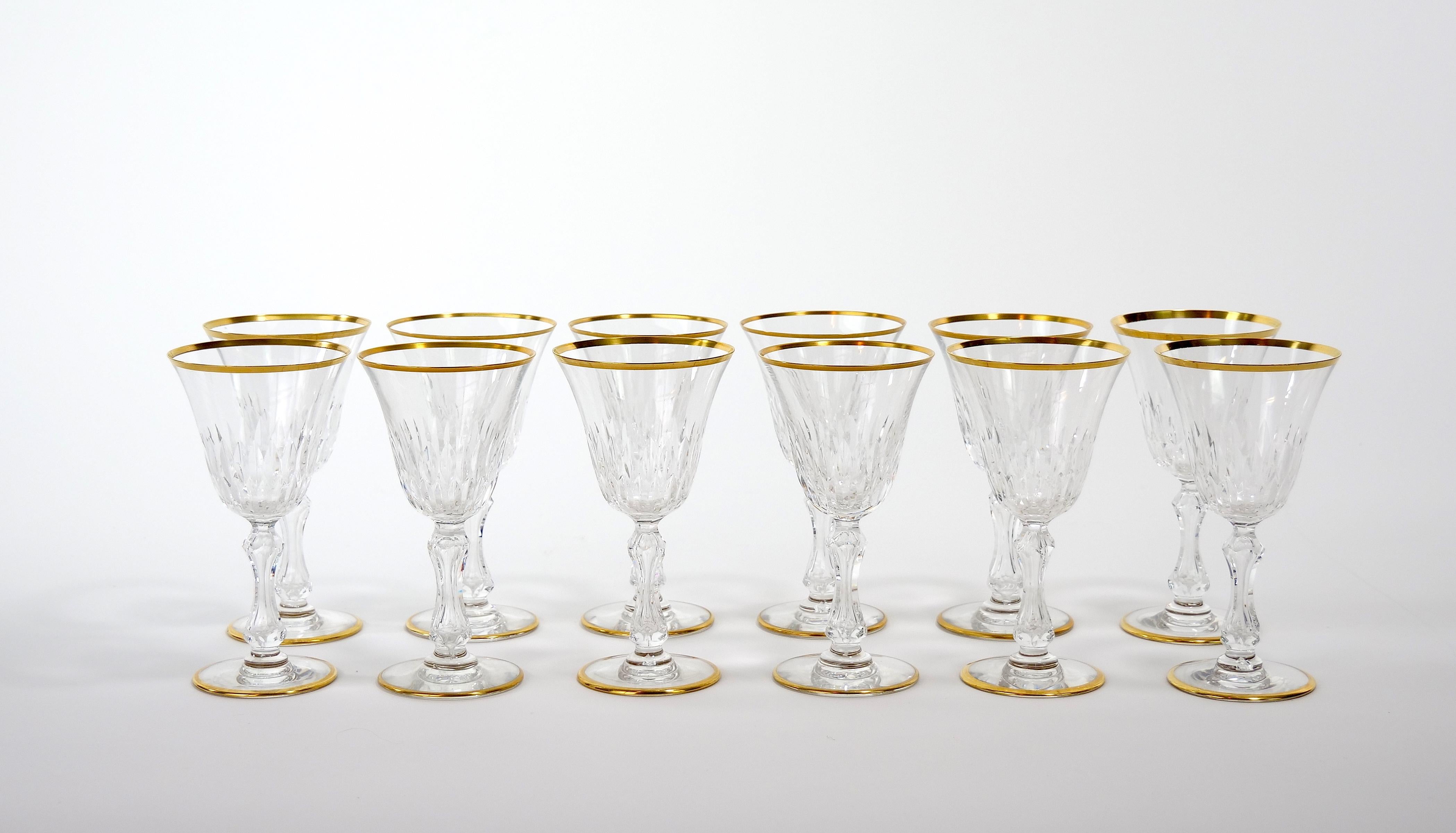 large and richly hand cut and mouth blown with hand gilt gold trim top / base barware and tableware glassware service for 12 people. Each glass features a deep cuts that allow the light to retract and shine to a brilliant finish from any angle.