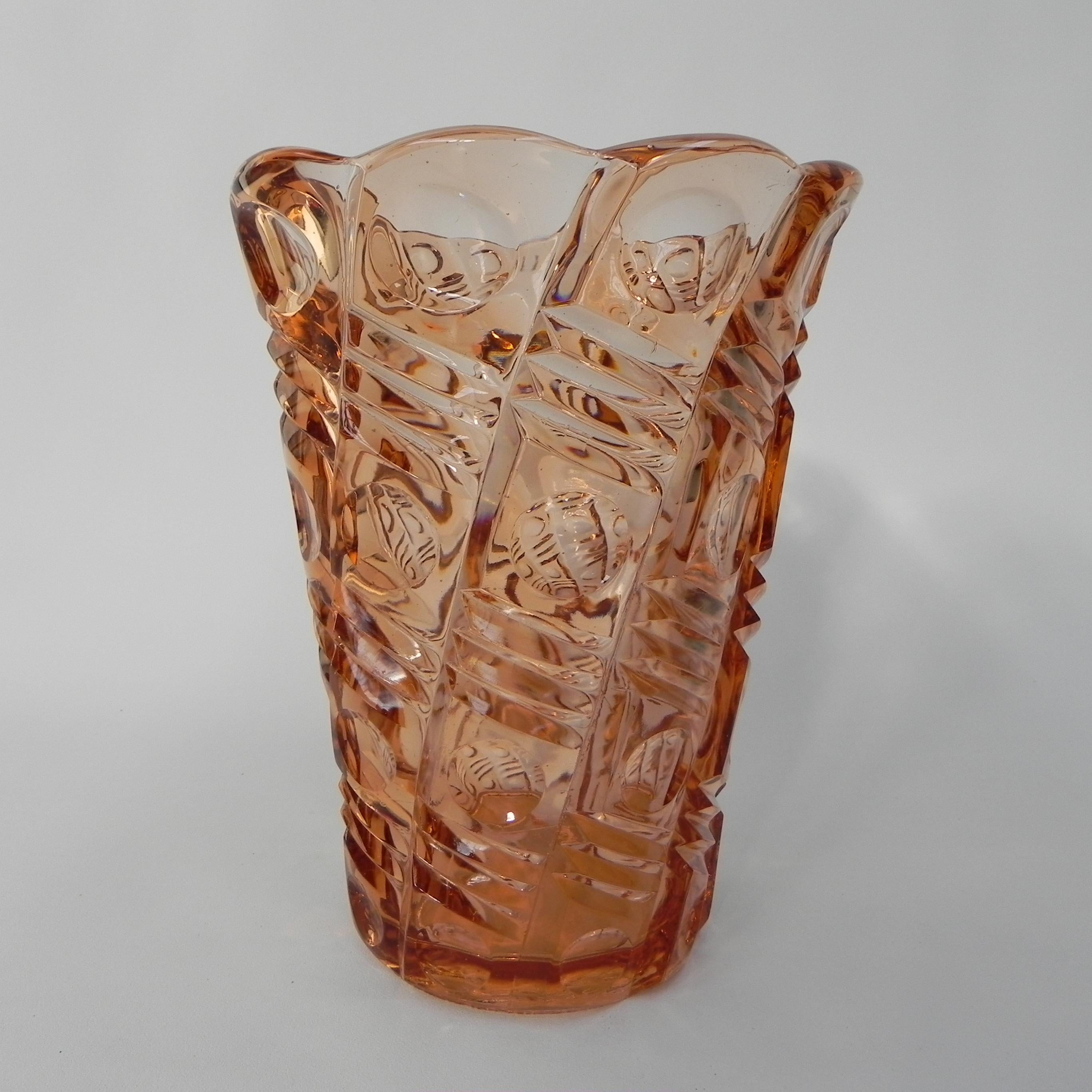 A 9-sided model vase from the Art Deco period
made of light salmon colored glass.

Height: 29.5 cm.
Ø: 22.5 cm.
Origin: Czechoslovakia, 1930s.
Material: glass.
