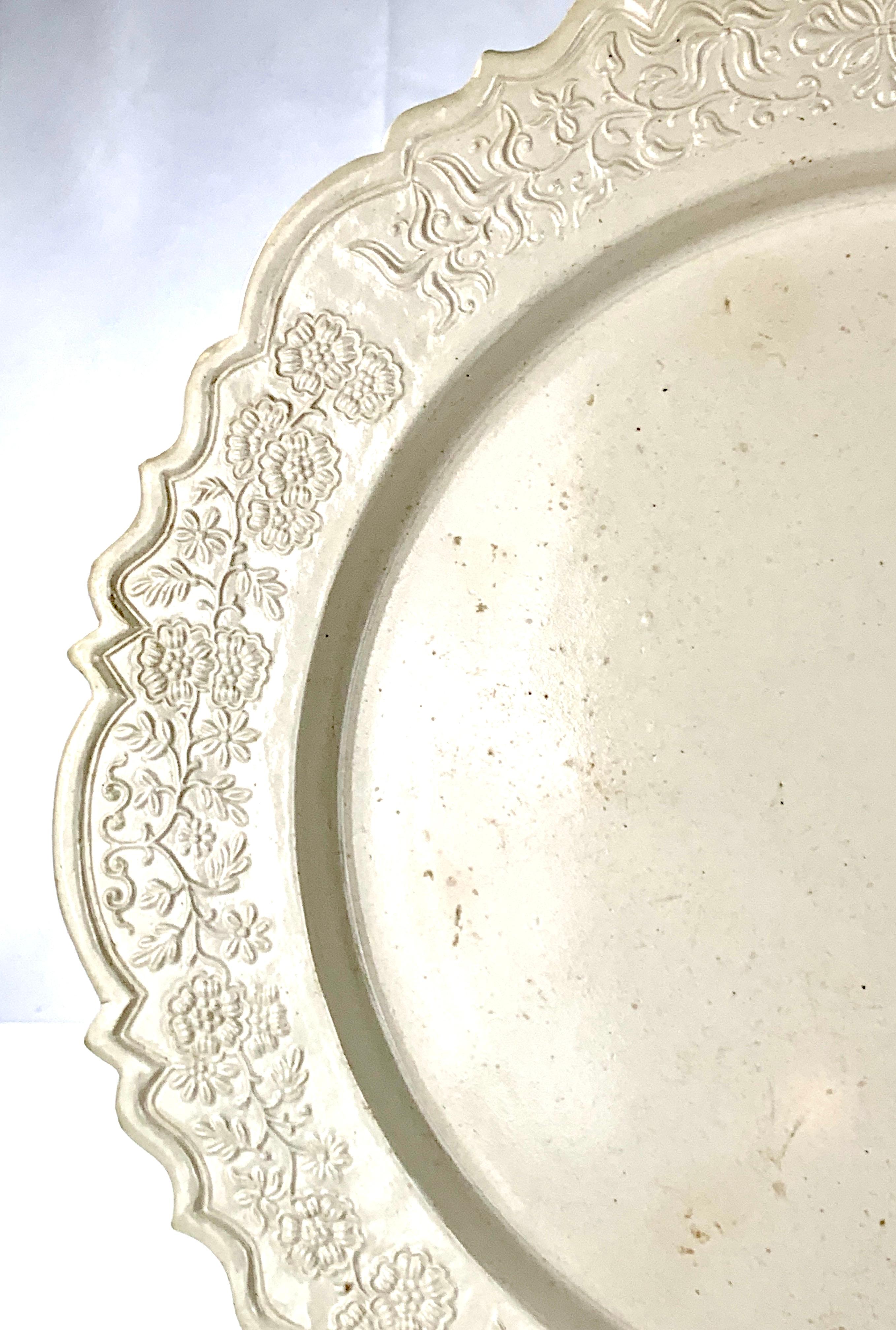This salt-glazed stoneware charger is an exquisite piece of early Americana.* The floral design on the border is graceful and charming showing a variety of flowers on the vine. It was made in England. In the mid 18th century stoneware was a staple