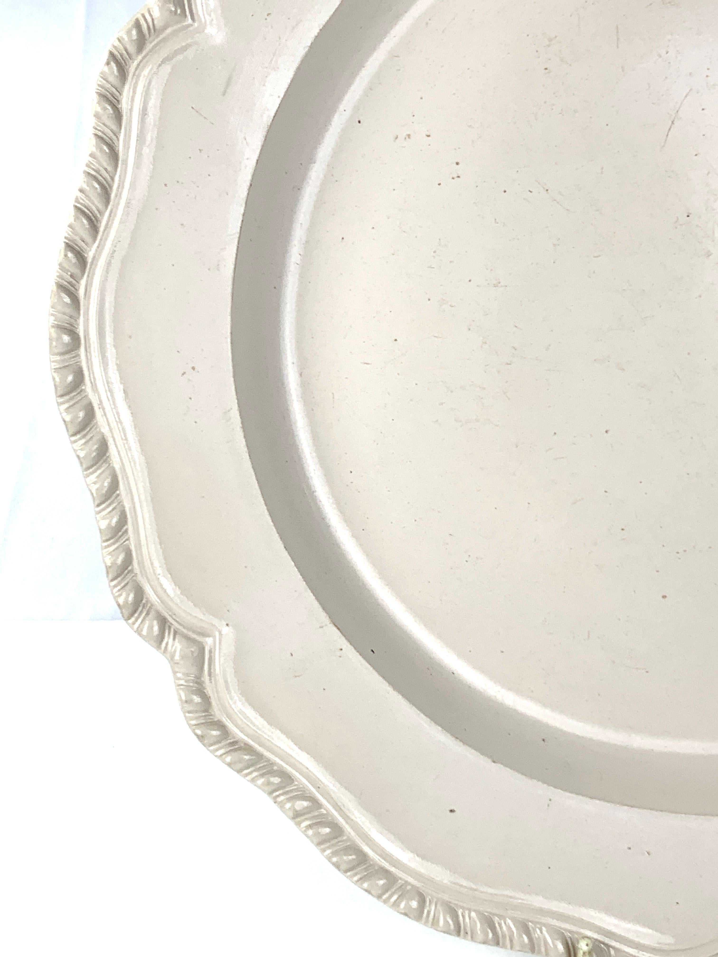 Provenance: The Collection of Sir Samuel Hoare* 
This large salt-glaze charger was made in Staffordshire, England, in the 18th century, circa 1765. 
The design is elegant and straightforward: the only decoration is the lobed and gadrooned edge. 
