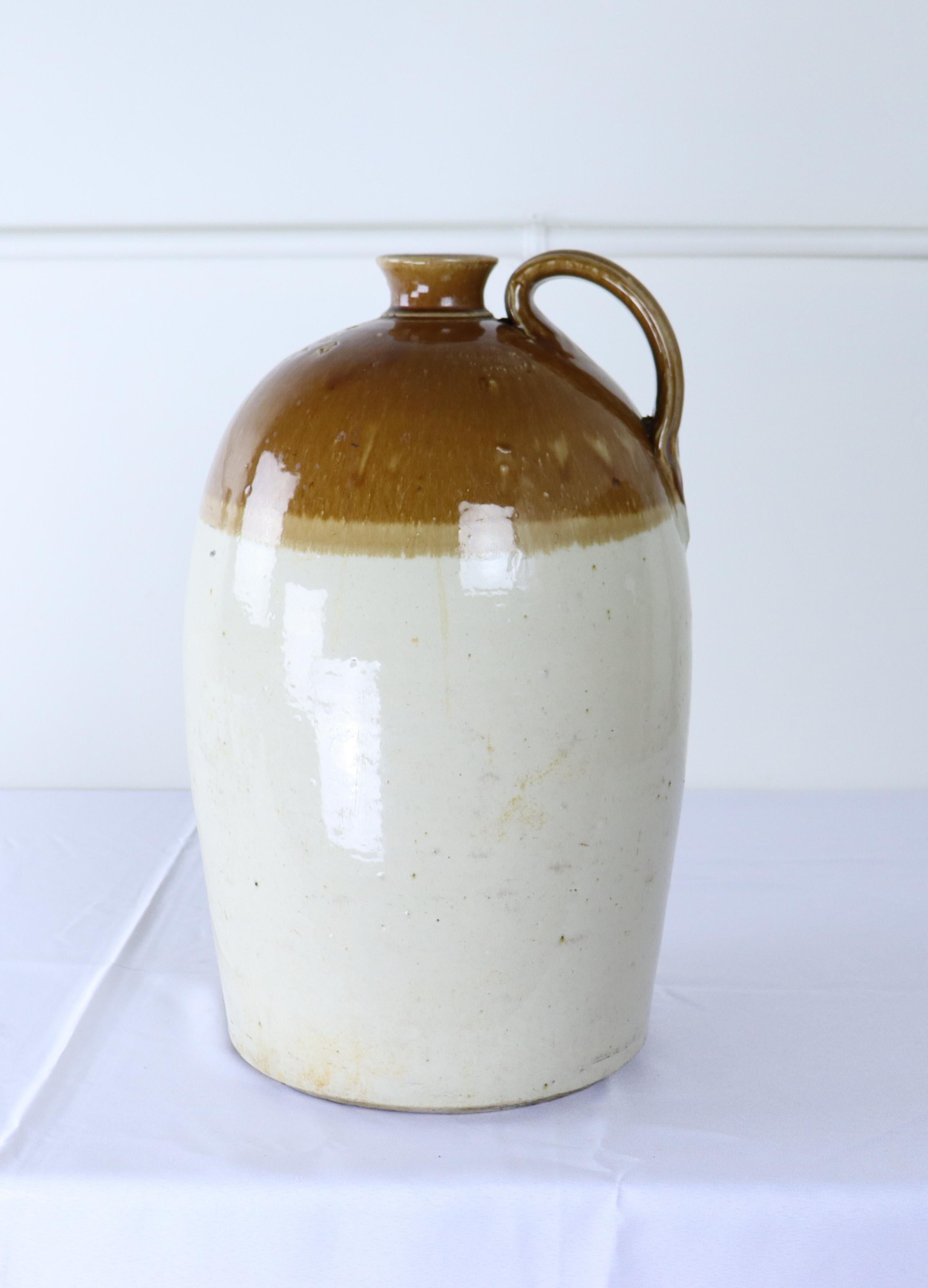 A large salt glazed ceramic brewery jug, manufacturered in the mid 19th Century by Port Dundas Pottery.  The glaze is in good antique condition.  Note the maker's thumbprint mark at the base of the handle.  There is a small chip at the mouth of the