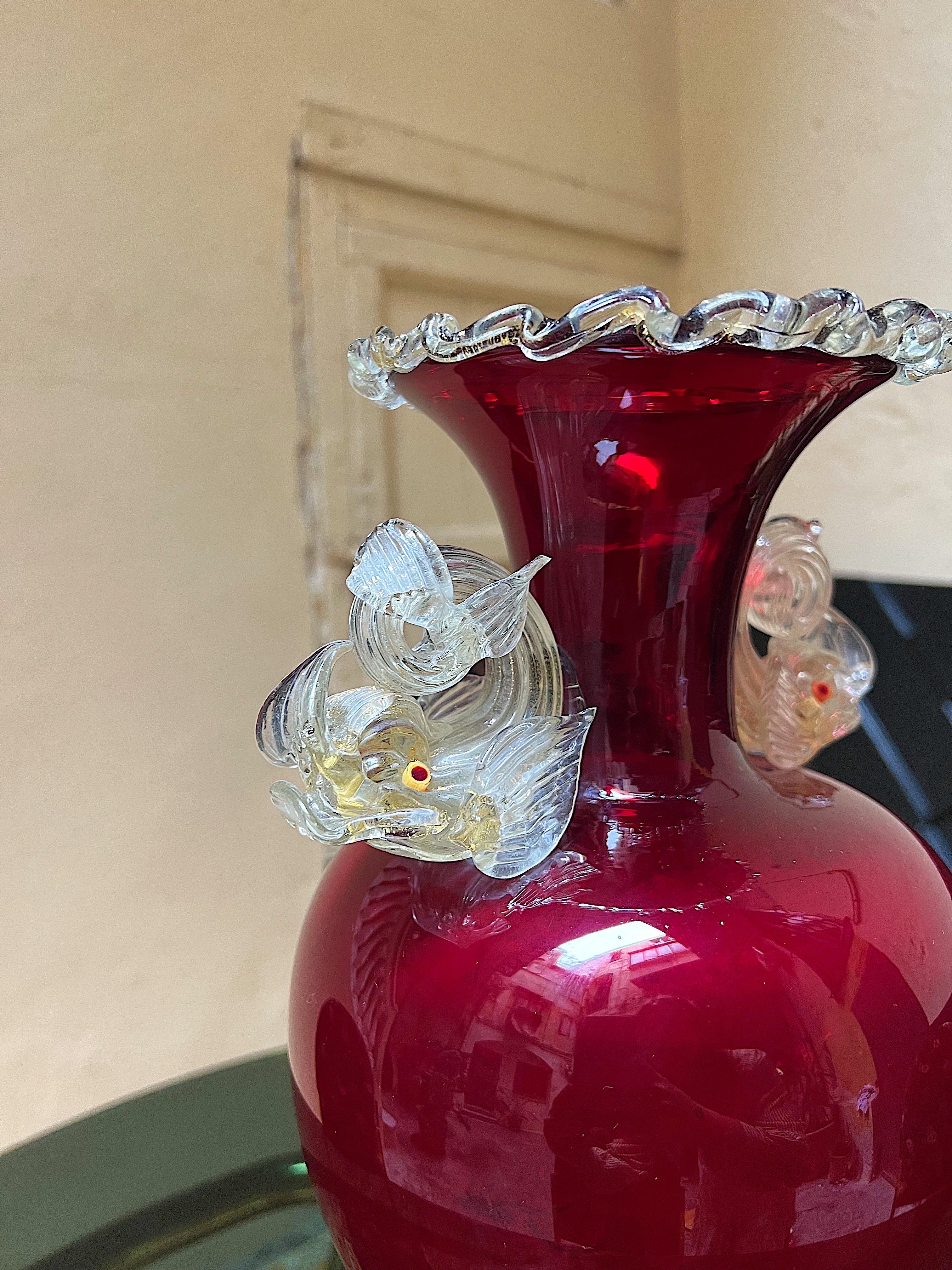 An exceptional example of Venetian glassblowing mastery, this large and impressive vase made by Antonio Salviati is sure to impress! All handblown elements are fused together to create this masterpiece.

 Its in a vibrant apple red, embellished