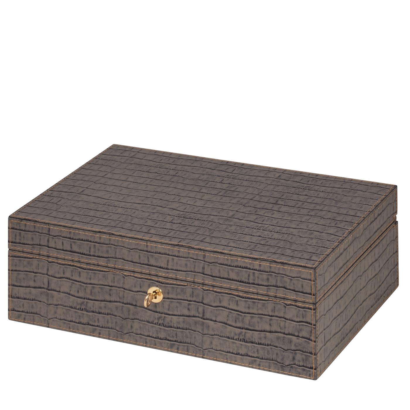 This superb humidor is a perfect gift or precious companion for the cigar lover. The walnut wood case is externally covered with fine leather that can be customized in color and texture. Inside, a cedar wood lining insures a perfect internal