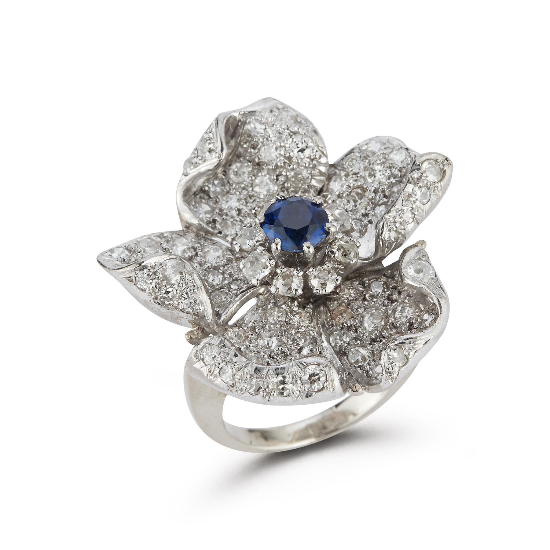Sapphire & Pave Diamond Flower Cocktail Ring, 1 round cut sapphire surrounded by pave diamonds
Ring size: 8 
Re sizable free of charge 
Gold Type: 14K White Gold 