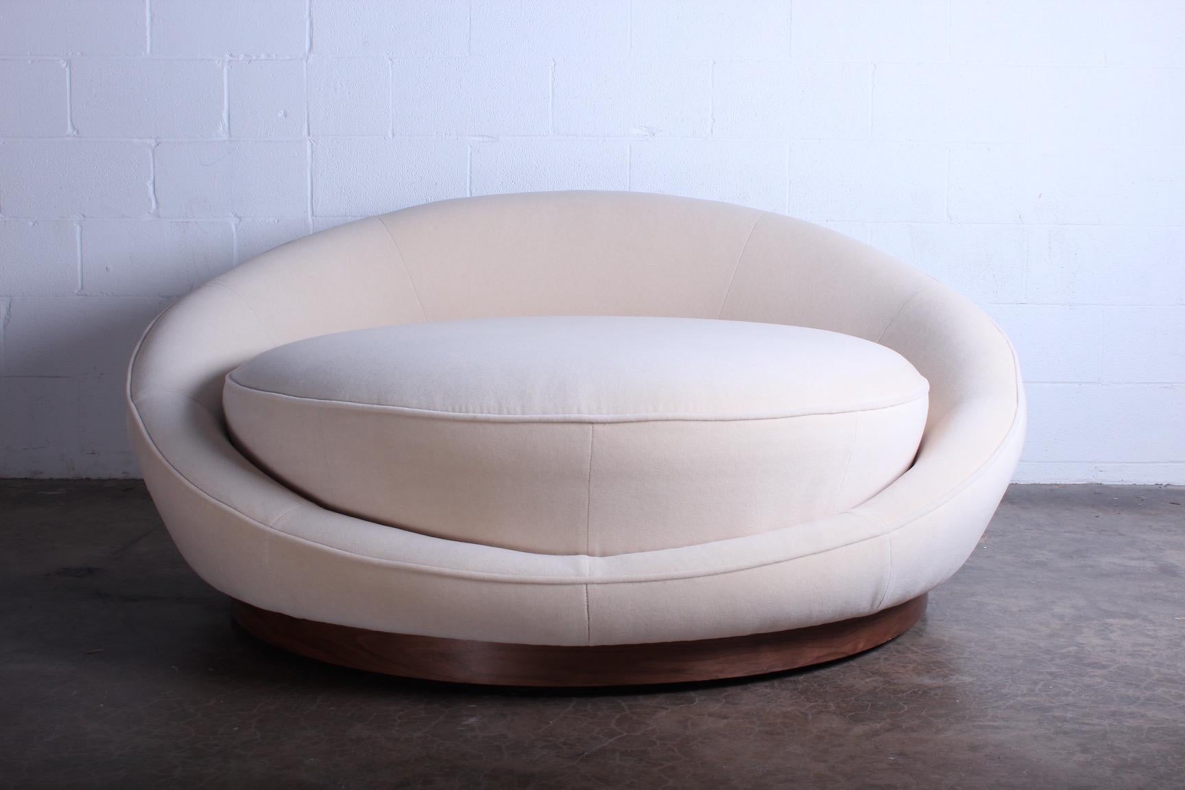 A large scale satellite lounge chair designed by Milo Baughman for Thayer Coggin. Upholstered in mohair with walnut plinth base concealing casters.