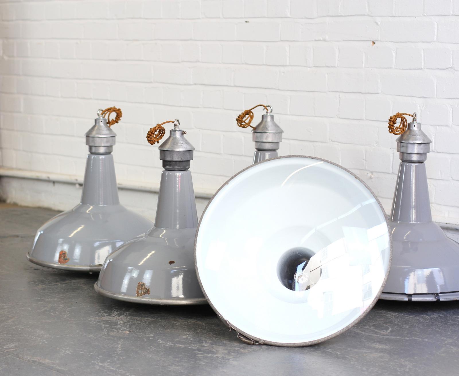 Large saw mill lights by Benjamin, circa 1950s

- Price is per light (10 available)
- Vitreous grey enamel shades
- Domed glass reflectors
- Aluminium tops
- Takes E27 fitting bulbs
- Comes with 100cm of gold twist cable
- Comes with