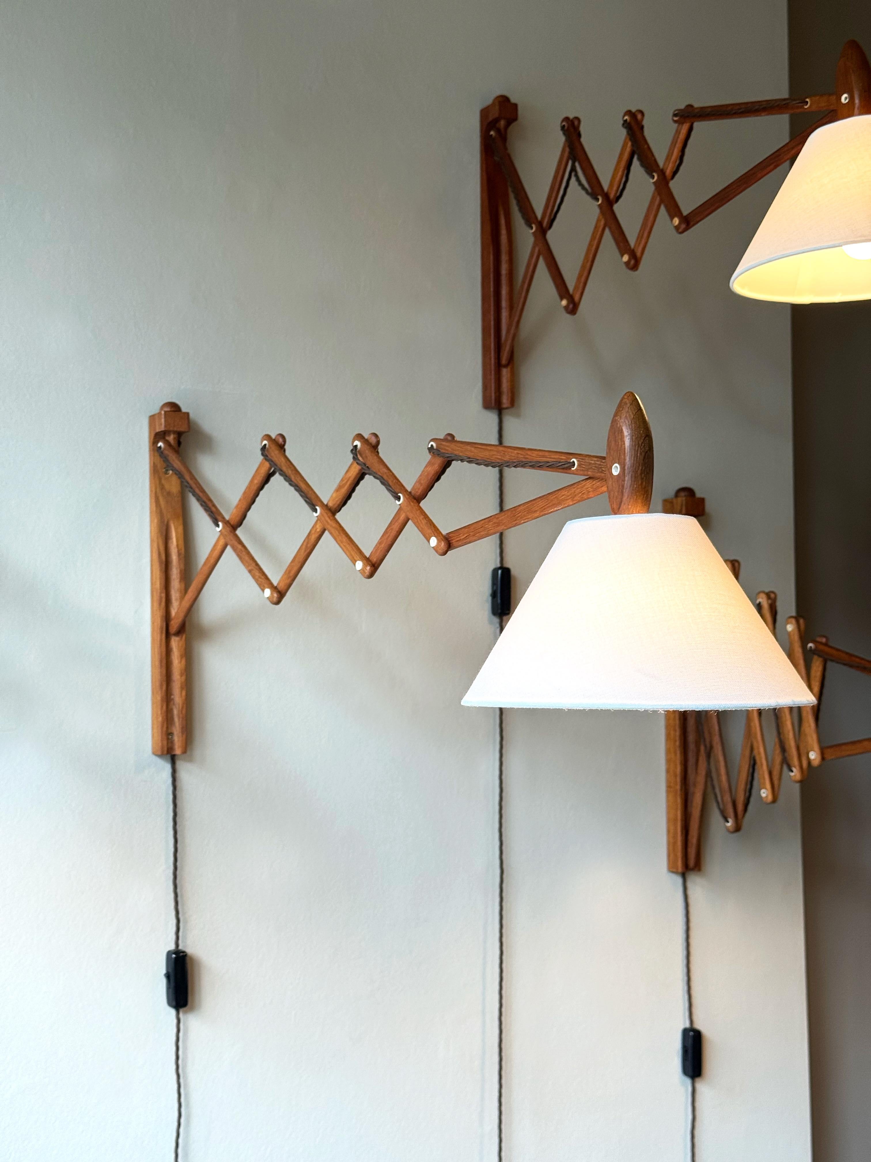 A wooden 'Sax' (scissor) wall lamp designed by Erik Hansen for Le Klint, Denmark, 1952.

Since the 1950’s the ‘Sax’ lamp has been produced as an uplighter and a down lighter in different types of wood. The new cable is antique-brown coloured fabric