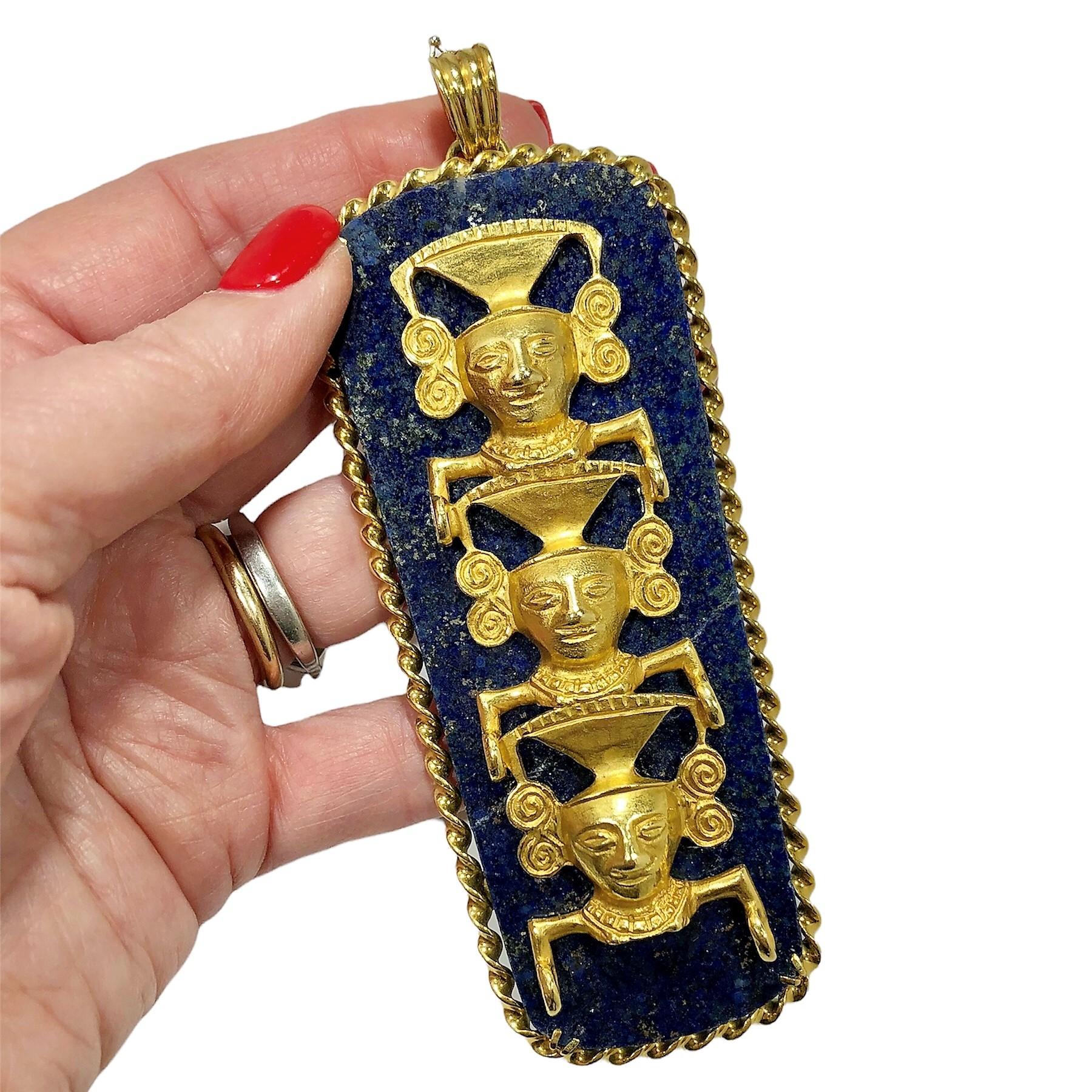 This wonderful and fanciful Totem pendant was crafted from an enormous slab of Lapis-Lazuli with three 18k yellow gold Pre-Colombian images stacked, one above the other. The slab itself is framed entirely by hand twisted 18k gold wire terminating on