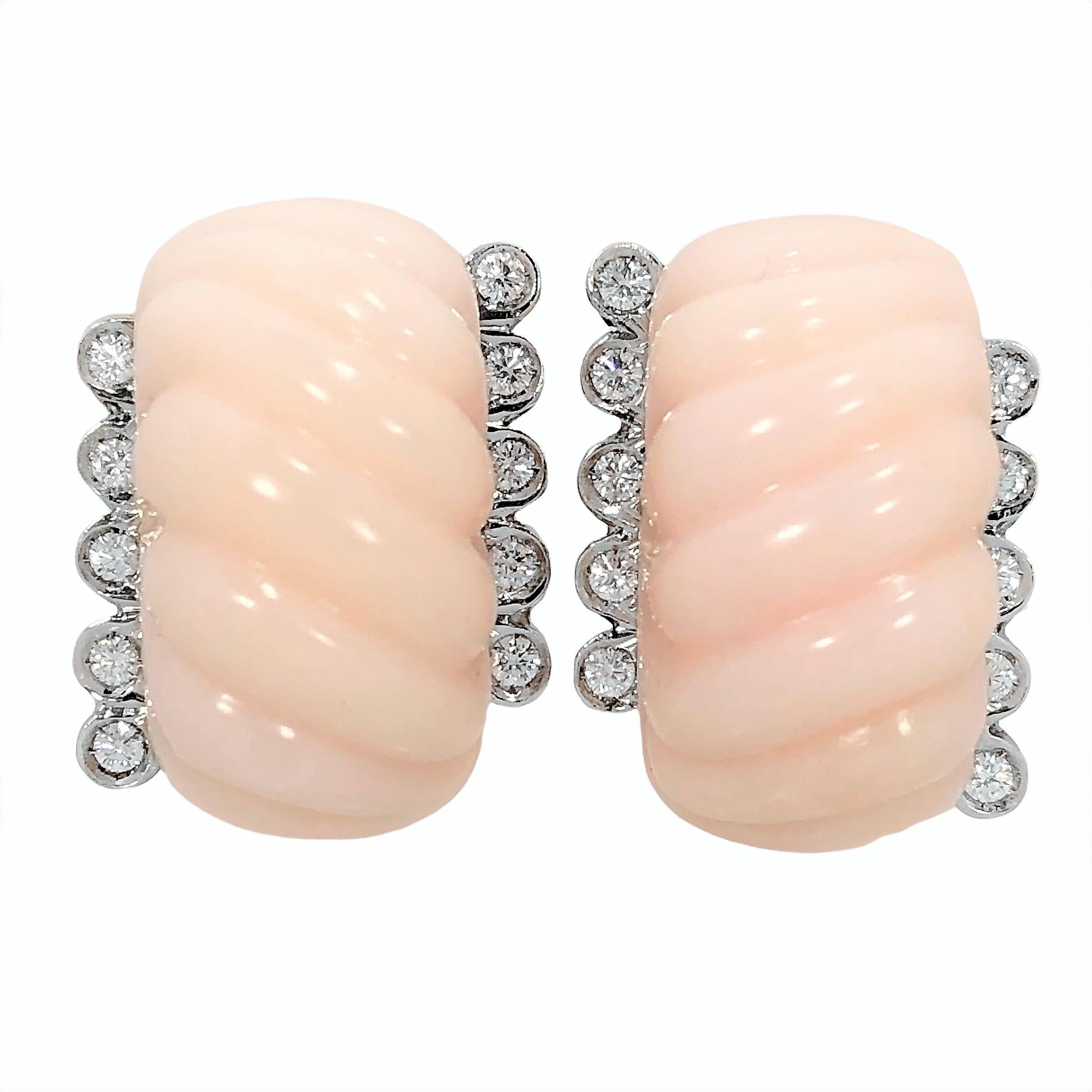 This classic design by Emis Beros is simple but very bold, with delicate colored angel skin coral, fluted cabochons, flanked by five brilliant cut diamonds on each side. Total approximate diamond weight is 1.00ct of overall  F/G color and VS1