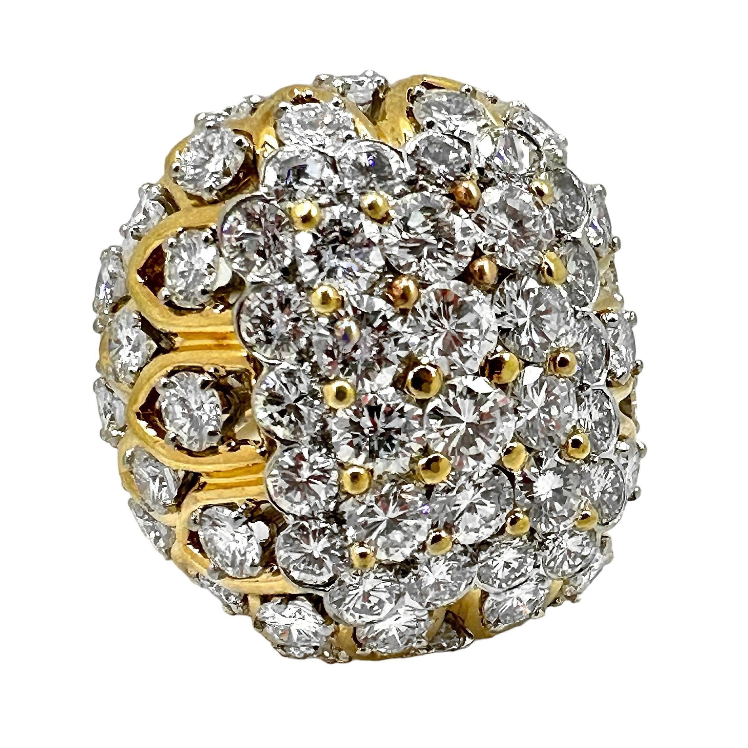 Made in the 1970's, this large cocktail ring scintillates brilliantly from every surface. A platinum plate, comprising the entire top of the ring is set with large very high quality brilliant cut diamonds. Surrounding this, down to the finger line,