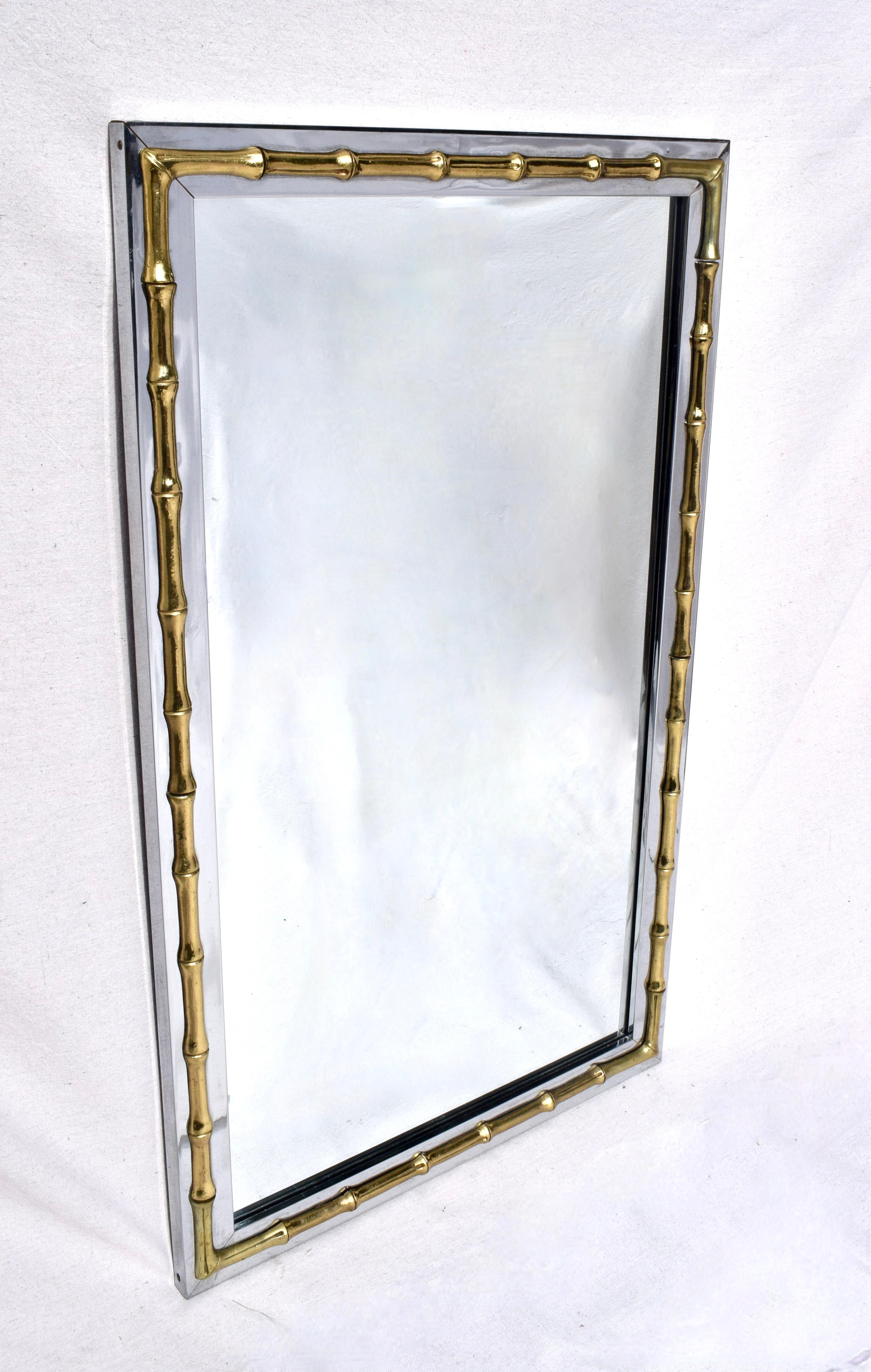 Large scale mirror of polished chrome embellished with faux bamboo brass detailing in the Hollywood Regency style. Solidly 70' Dorothy Lerner showroom & production; Philadelphia, Pa. Ready to hang, substantial in weight with original mirror.
