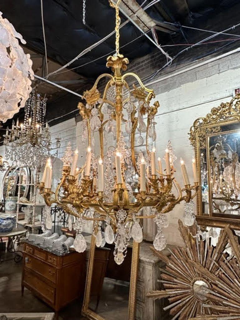 Magnificent large scale 19th century Dore' and rock crystal chandelier. Take notice of the figural images on the base. And also, large rock crystals, some in the shape of sea shells. So impressive! Stunning!!