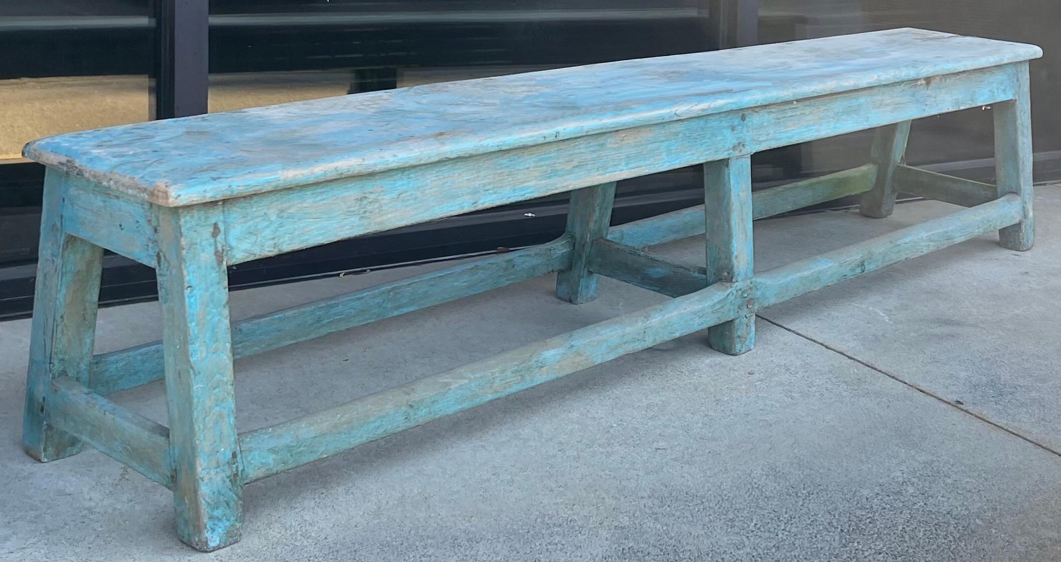 This original worn blue paint makes the French bench a special addition to a home. It is a late 19th century piece, and is long and primitive. It does have peg construction.