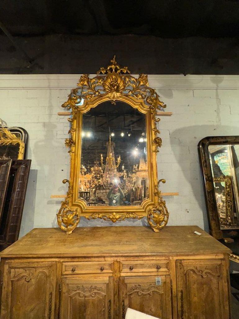 Eccezionale specchiera italiana del XIX secolo di grandi dimensioni in legno intagliato e dorato. Caratterizzato da una splendida patina dorata e da elaborati intagli nella parte superiore dello specchio. Una vera opera d'arte! Circa 1870
105h x 6w