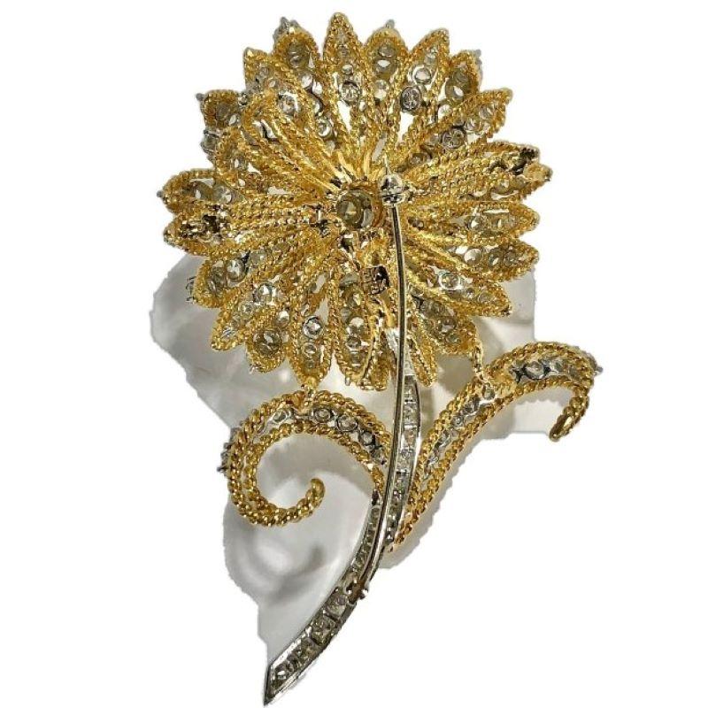 This visually powerful floral brooch is dazzling in appearance and is made to the very highest standards of the jewelry making craft. As would be expected of very fine pieces. each and every diamond of the estimated 12.5
carats total weight, is set