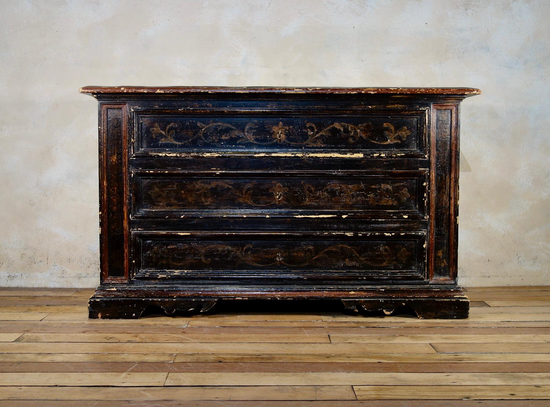 A large scale Italian painted chest of drawers - commode. 
Featuring three equal size drawers each with molded edges - framed by a pair of elongated two-tone molded panels situated either side of the drawers. 

Raised on elegantly shaped bracket