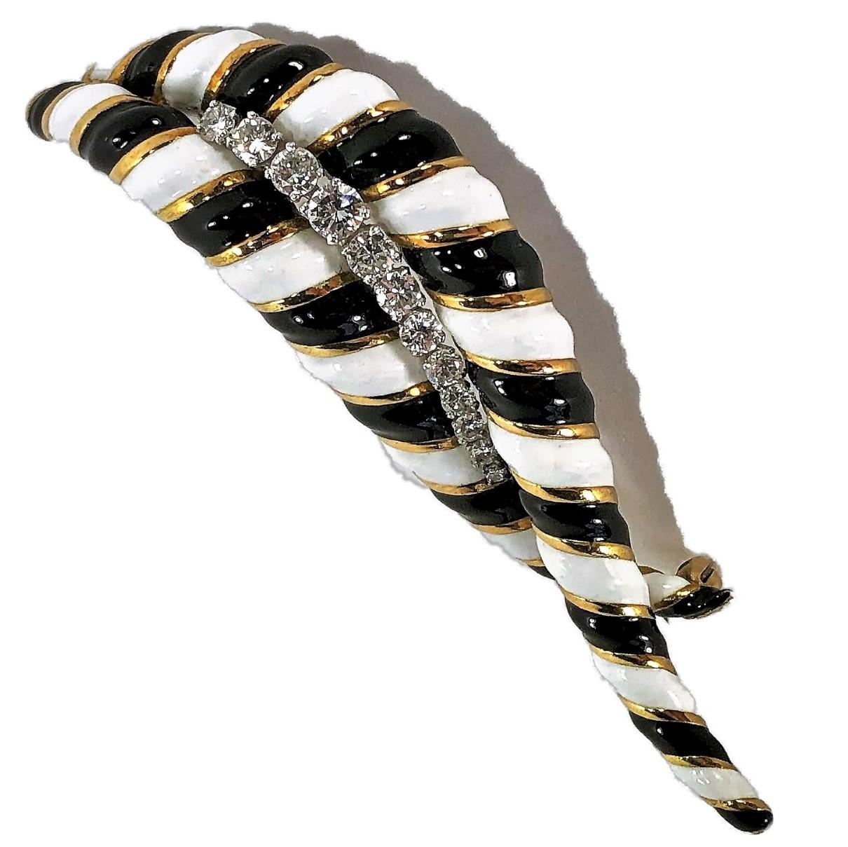 This large and graceful 18K Yellow Gold brooch measures 3 inches long
by 1 inch wide, and features alternating black and white enamel stripes 
delineated by yellow gold accents.
Set in the center are twelve brilliant cut diamonds with a total weight